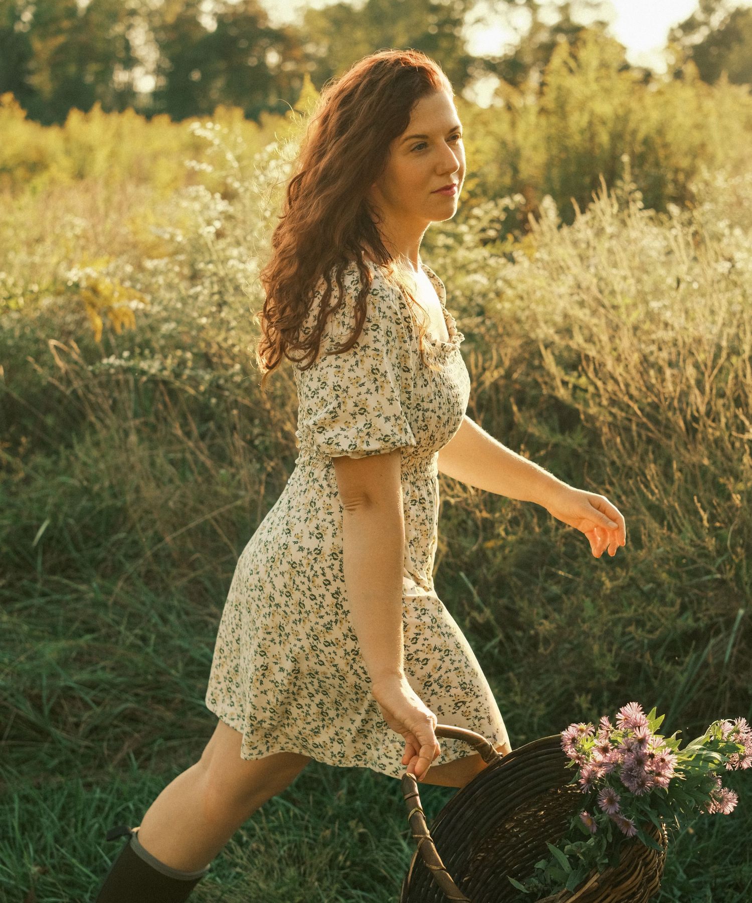 A person in a floral dress runs through a sunlit meadow at golden hour while wildflowers sway in the breeze.