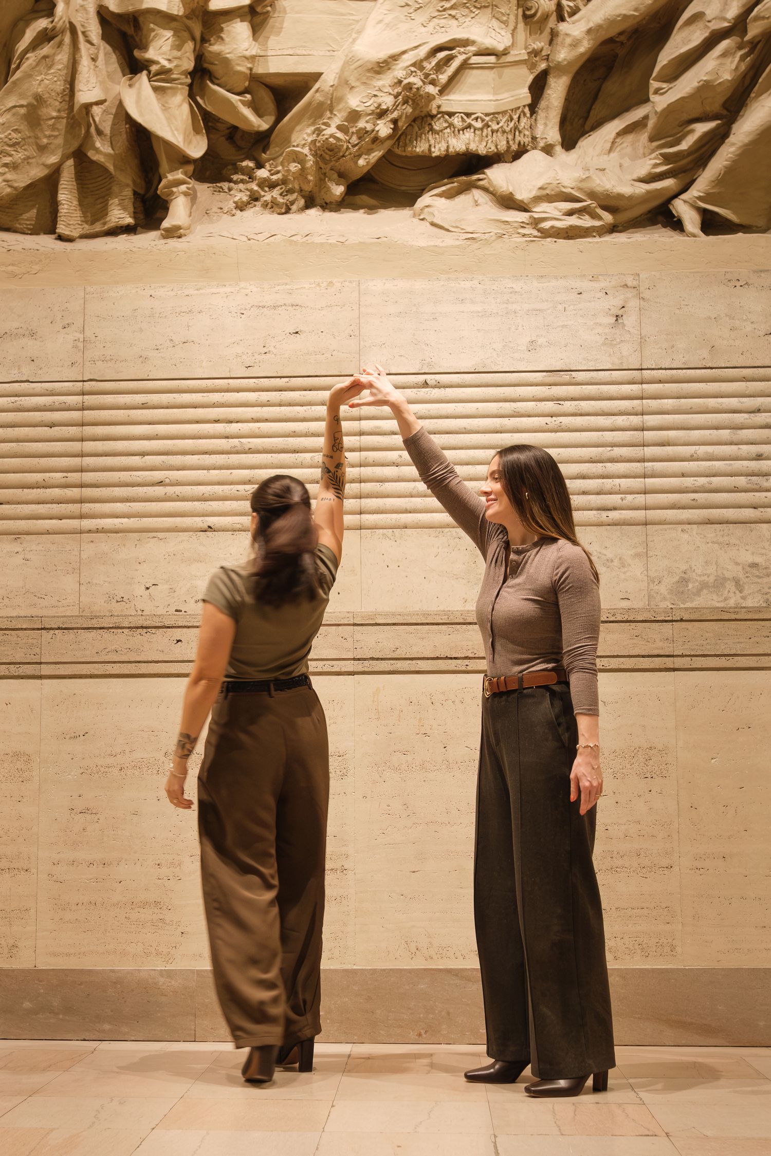 Two people in dark clothing interact on stone steps in a sepia-toned photo sequence.