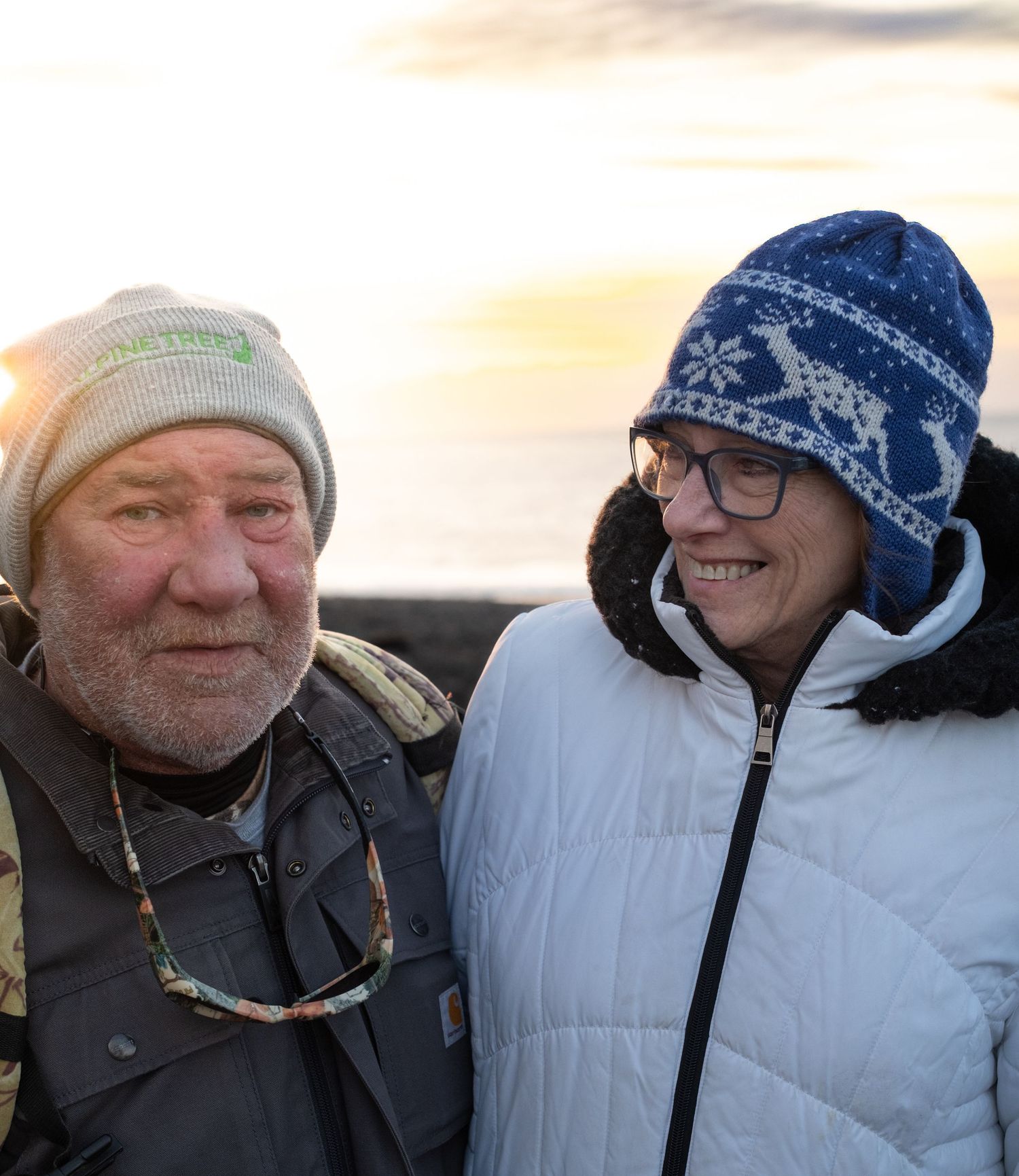 A series of headshots showing people wearing winter hats and coats against a bright outdoor background.