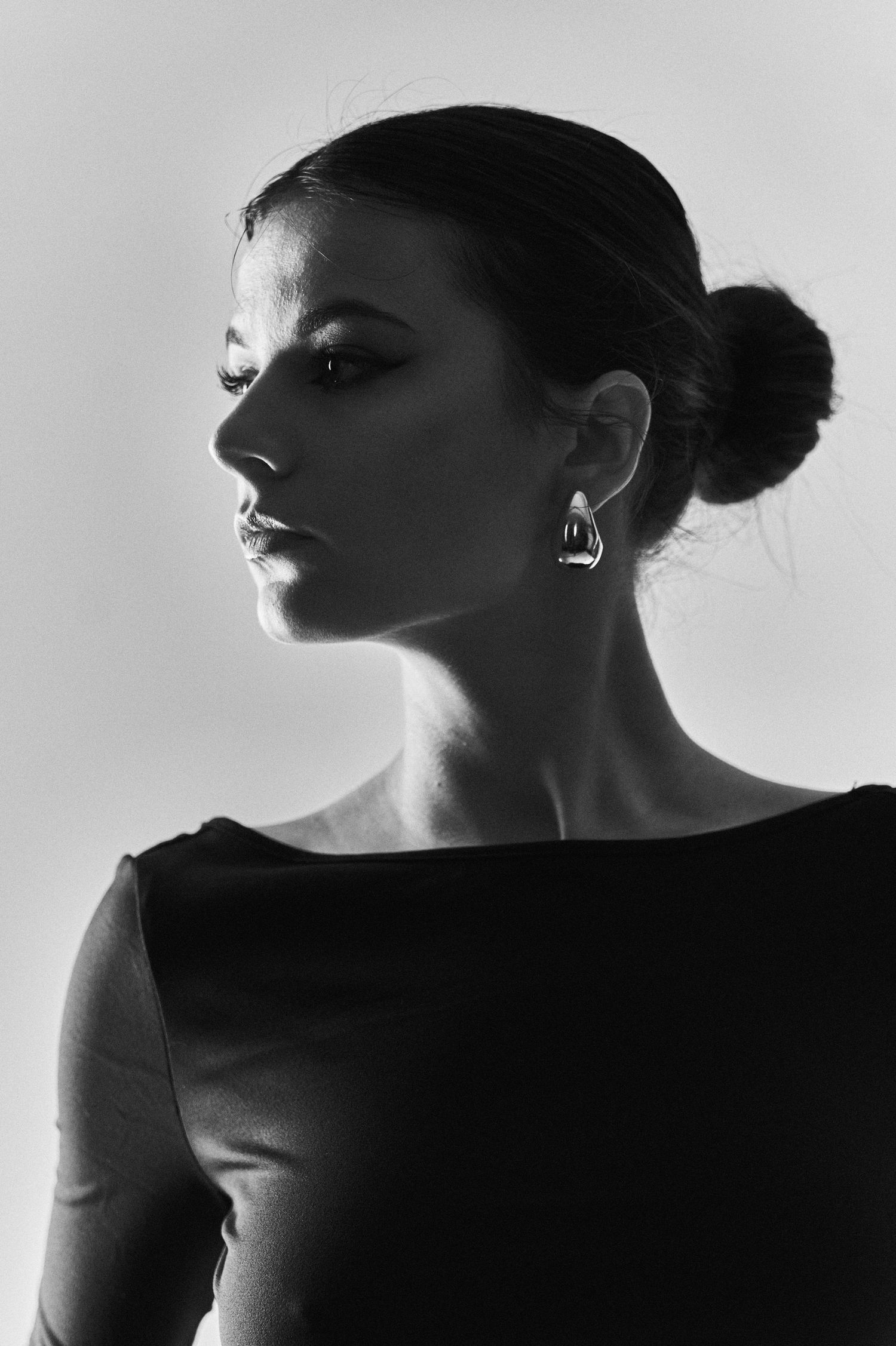 Artistic black and white silhouette series showing dramatic side profiles against a light background.