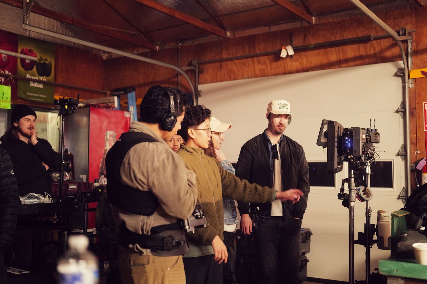 Film production crew working with equipment in studio space.