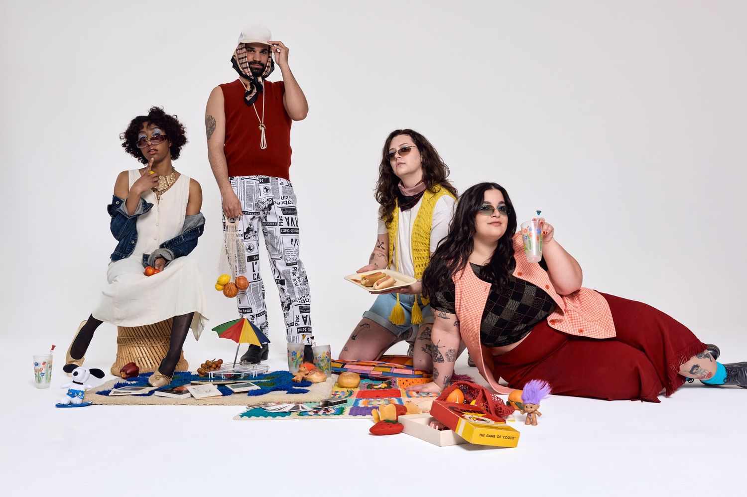 Fashion models in casual clothing posing together on white background for a lifestyle photoshoot.