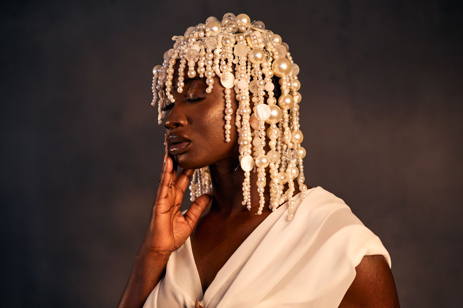 Portrait series showing dramatic lighting and expressions against dark background.