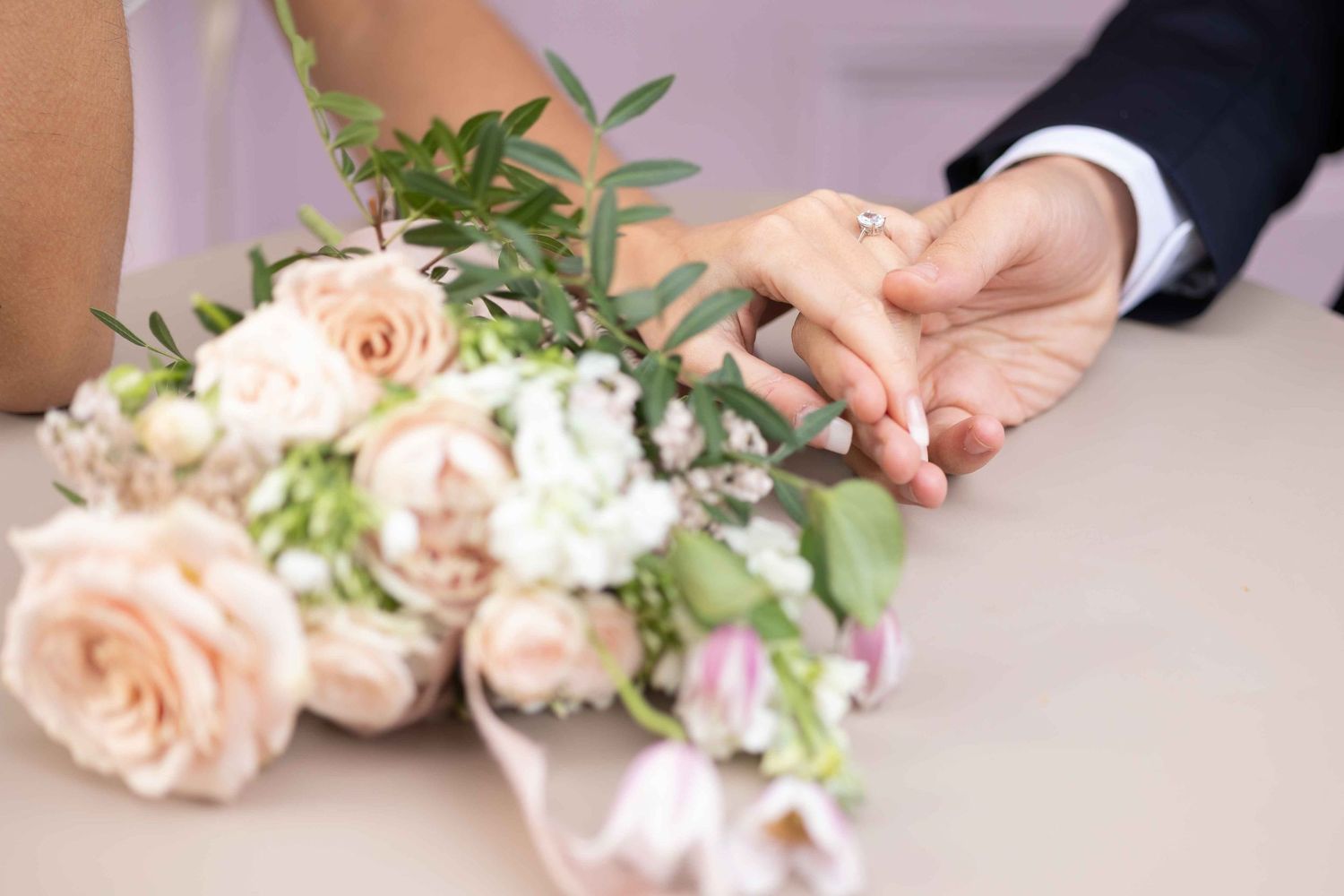 Bride and groom holding hands with elegant wedding bouquet, fine art wedding photography by Alba del Sol, London