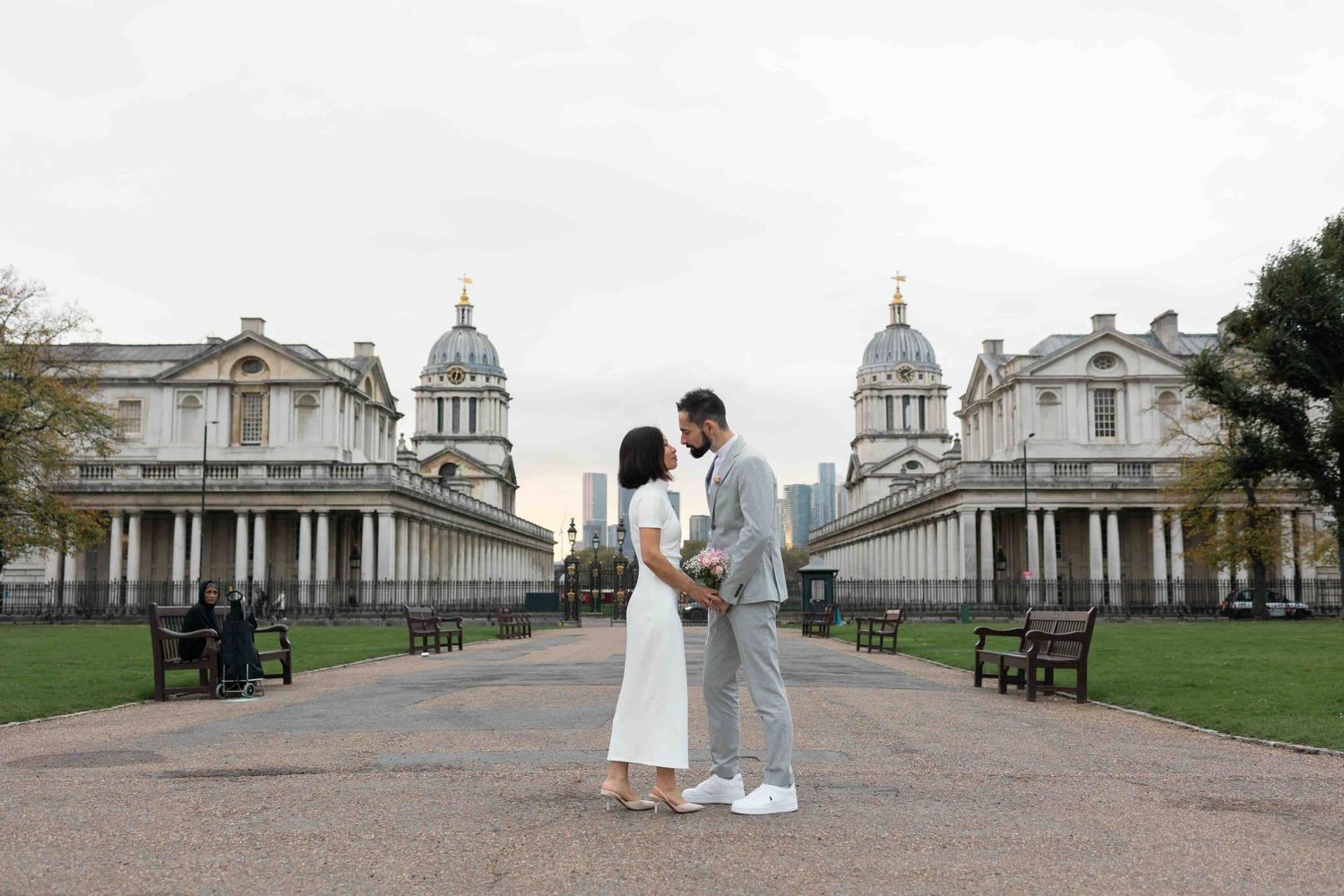 Elegant wedding couple about to kiss in front of the Old Royal Naval College in Greenwich, London — modern and romantic wedding portrait
