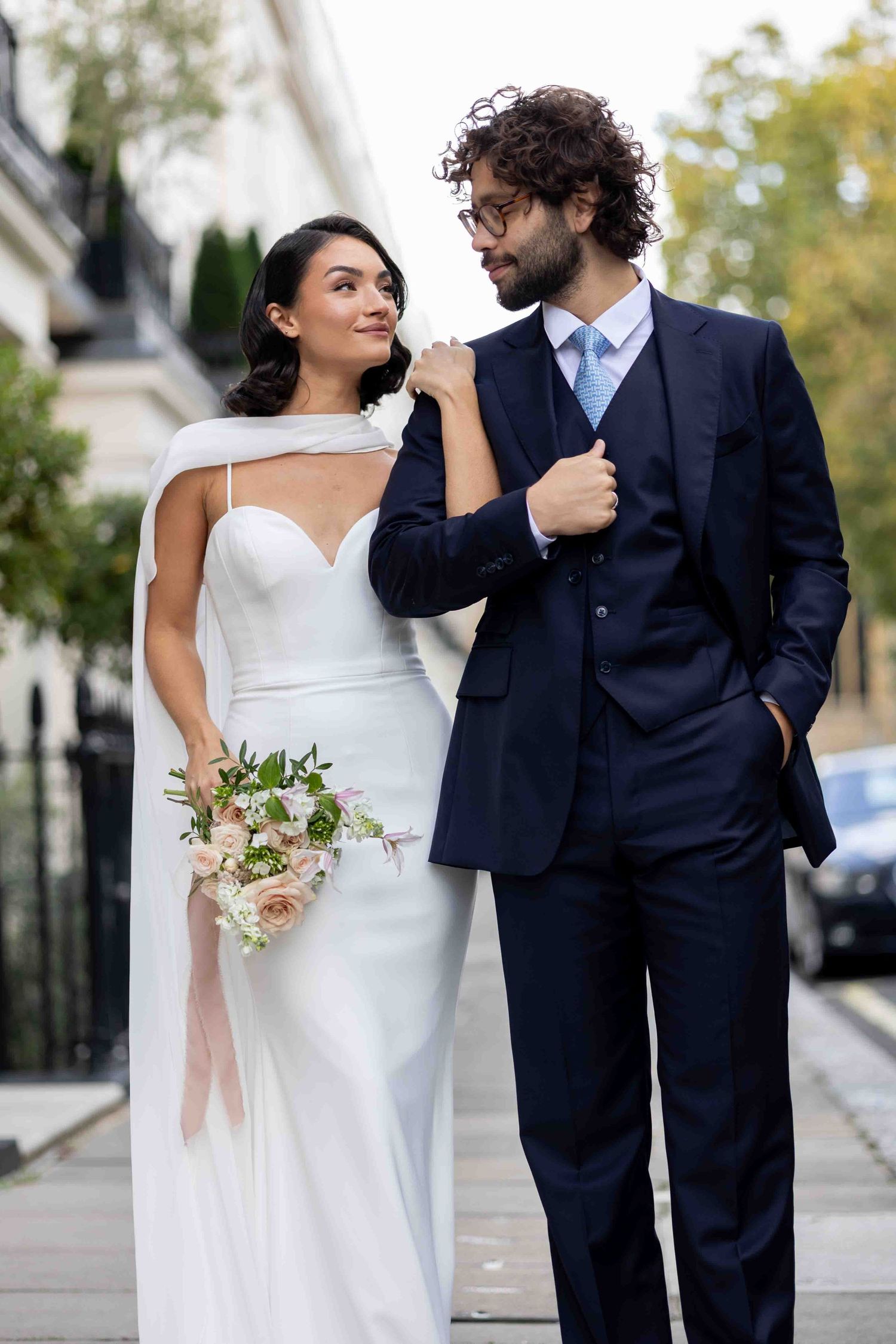Elegant bride and groom walking together with blush bouquet in Belgravia, London — timeless fine art wedding photography by Alba del Sol