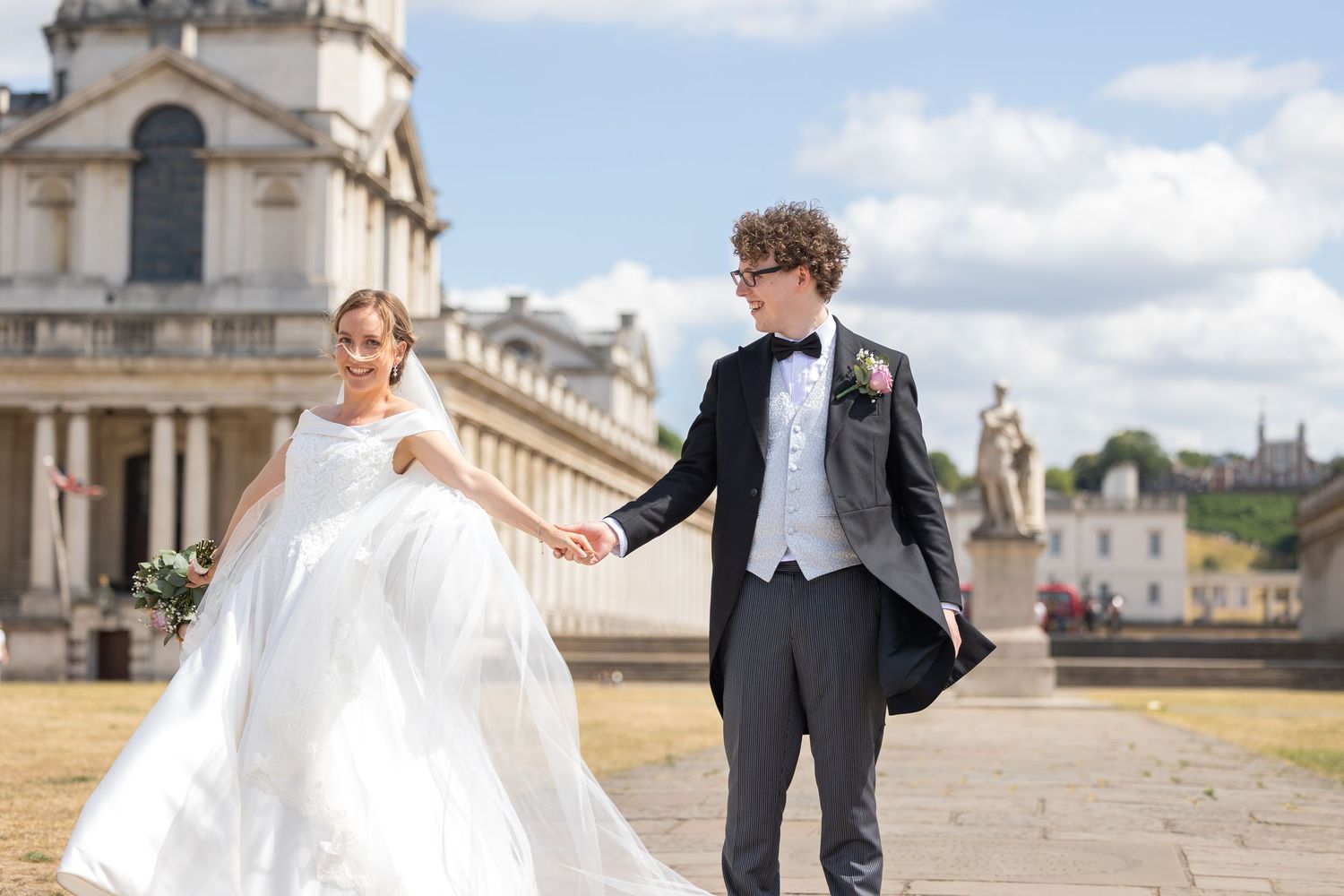 Joyful bride and groom holding hands at the Old Royal Naval College in Greenwich, London — timeless fine art wedding photography by Alba del