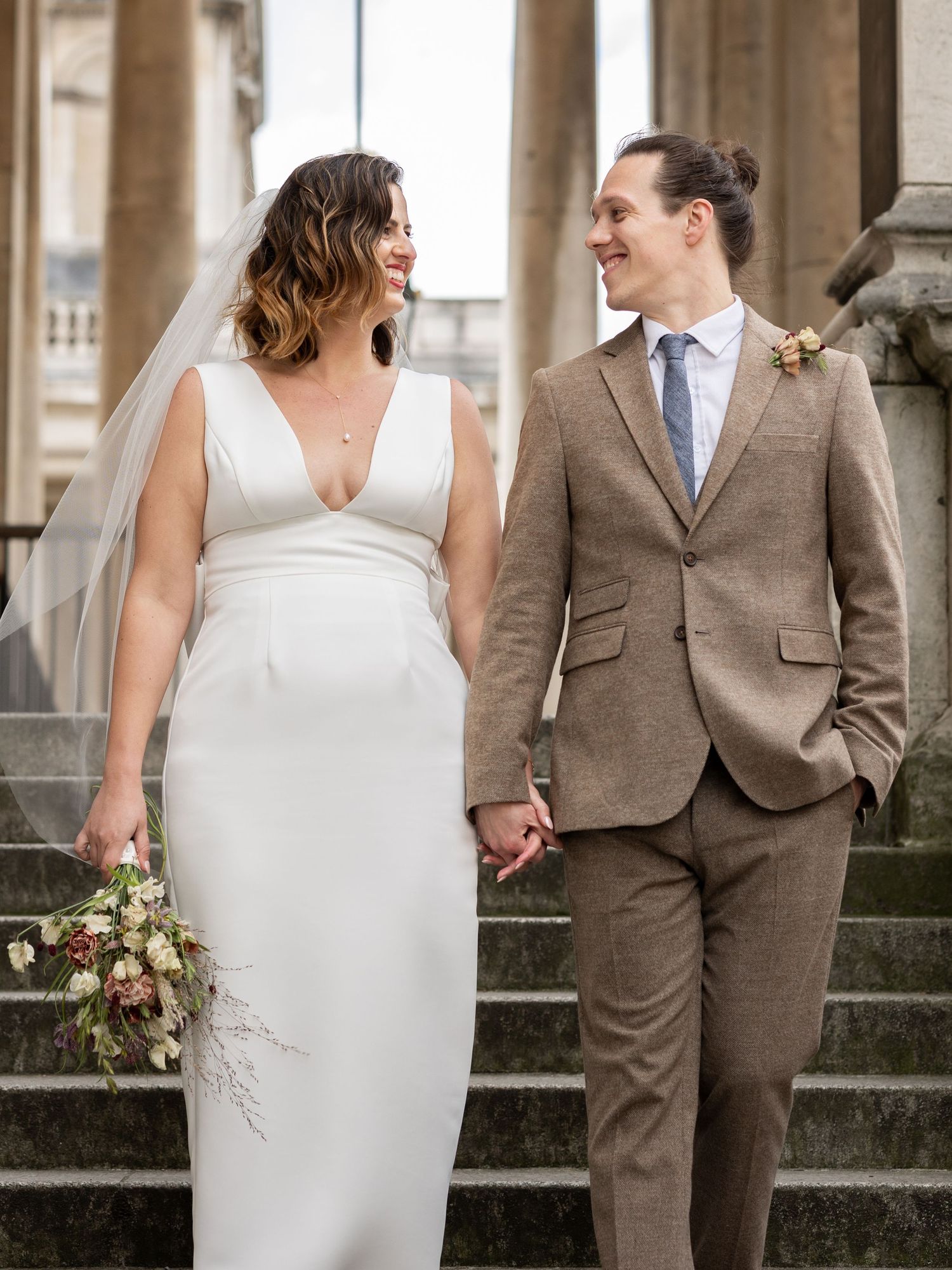 Bride and groom walking hand in hand at the Old Royal Naval College in London — elegant fine art wedding photography by Alba del Sol.