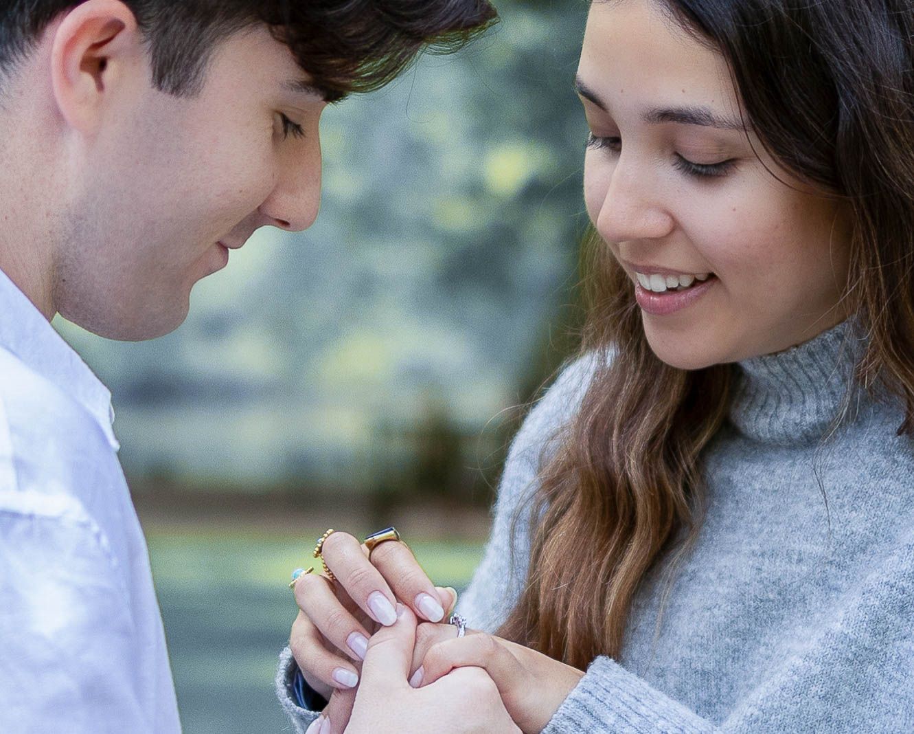 Intimate engagement portrait of a couple exchanging rings surrounded by soft natural light in London — timeless photography by Alba del Sol.