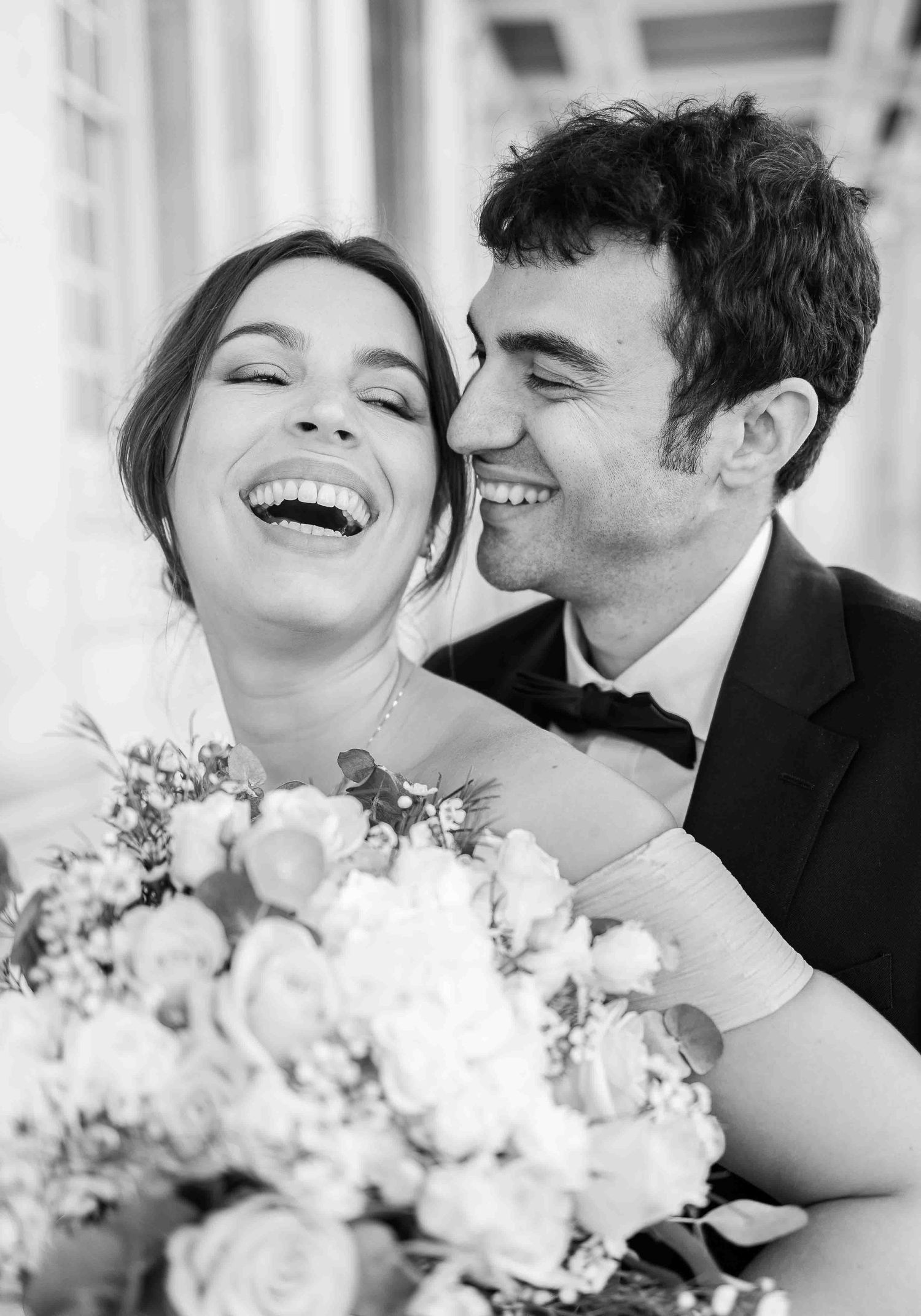 Romantic black and white portrait of a bride laughing in her groom’s arms at the Old Royal Naval College, London — fine art wedding photogra