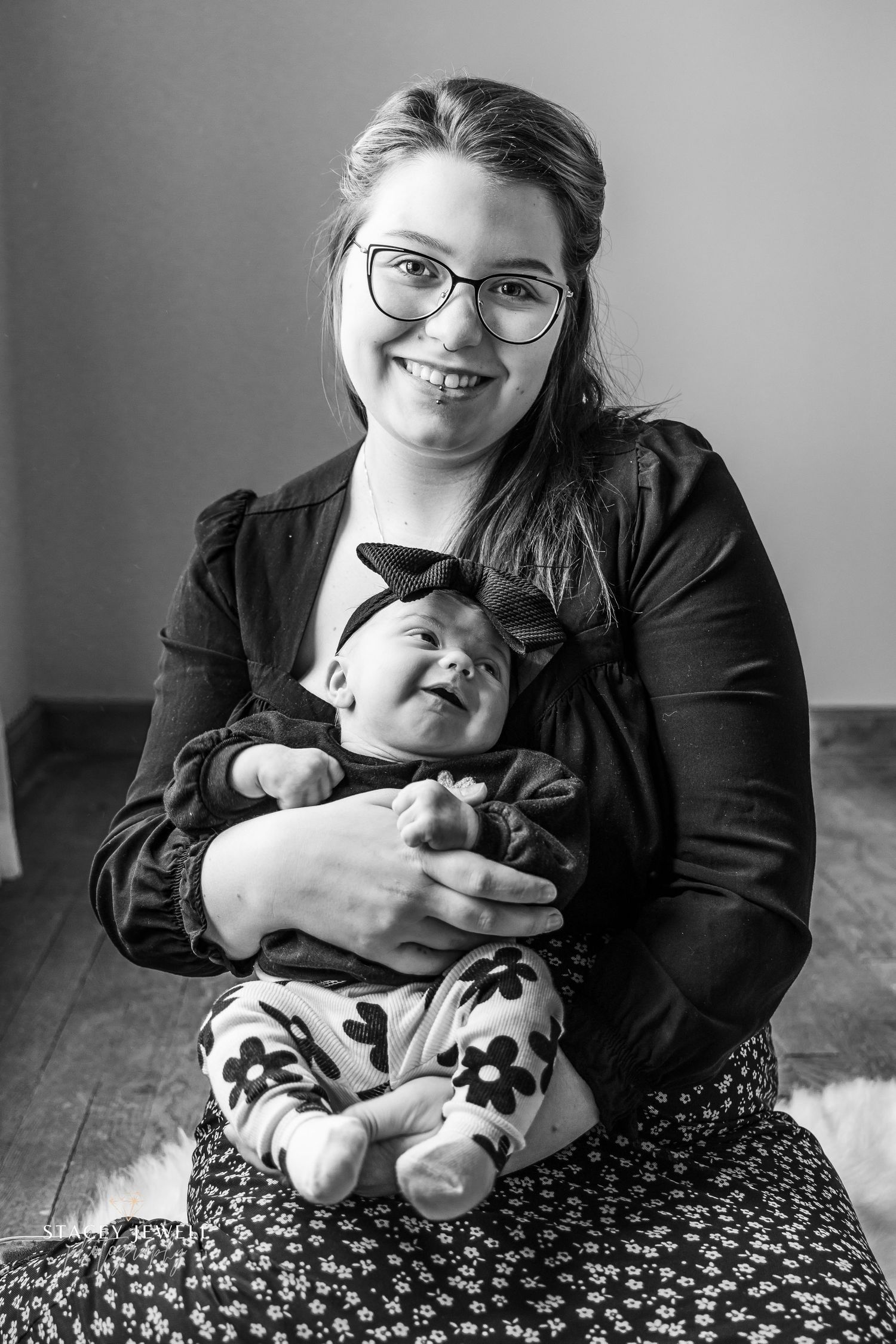 New mother holding her newborn in black and white