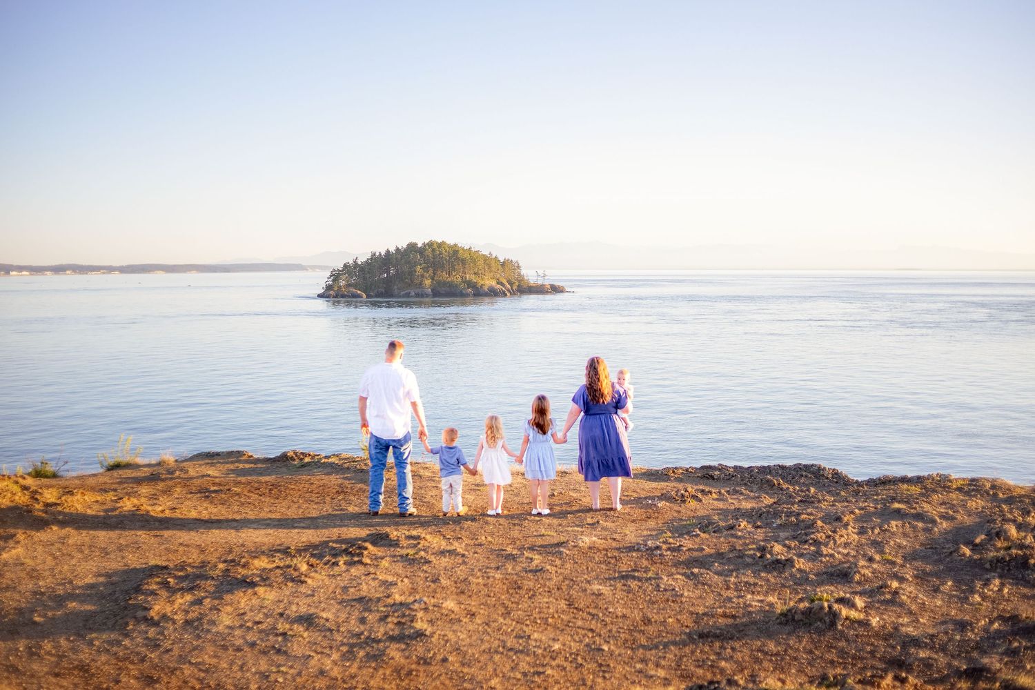 Golden hour family photo. Candid family photo. PNW family photo session overlooking puget sound. Outdoor family photos.