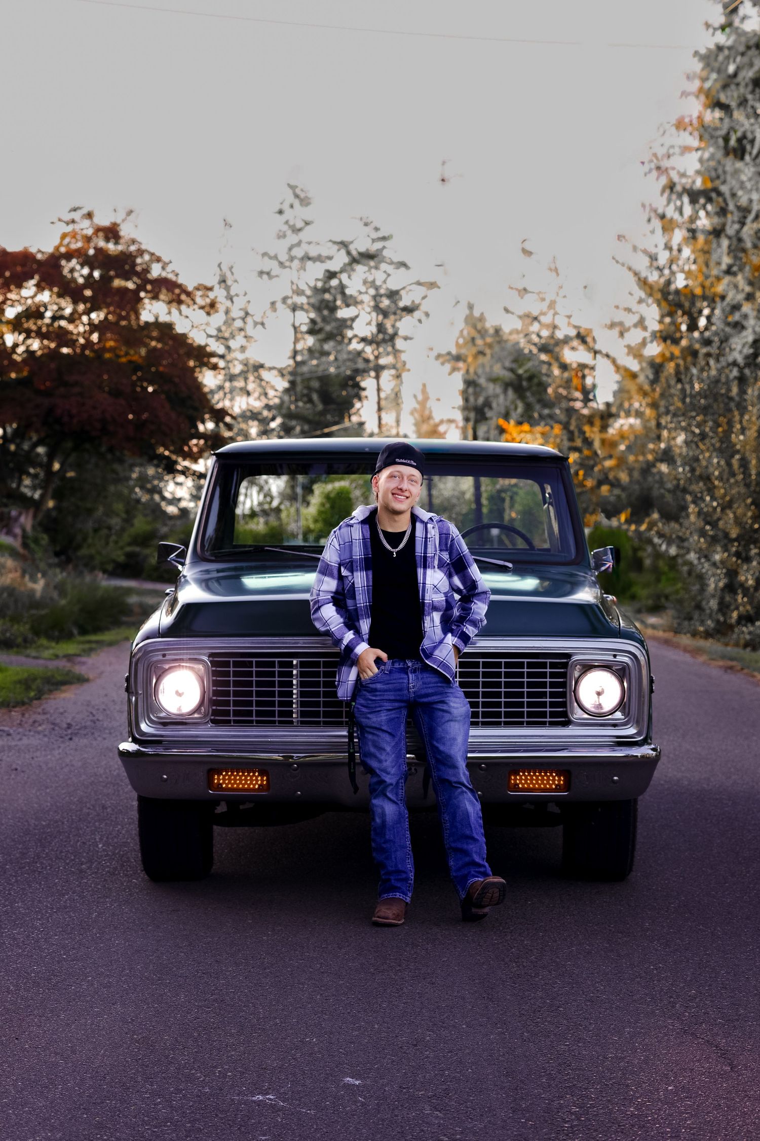 Senior photo at golden hour in Tulalip, Wa. outdoor senior photo. Truck in the background. Rugged senior photo. Male senior photo.