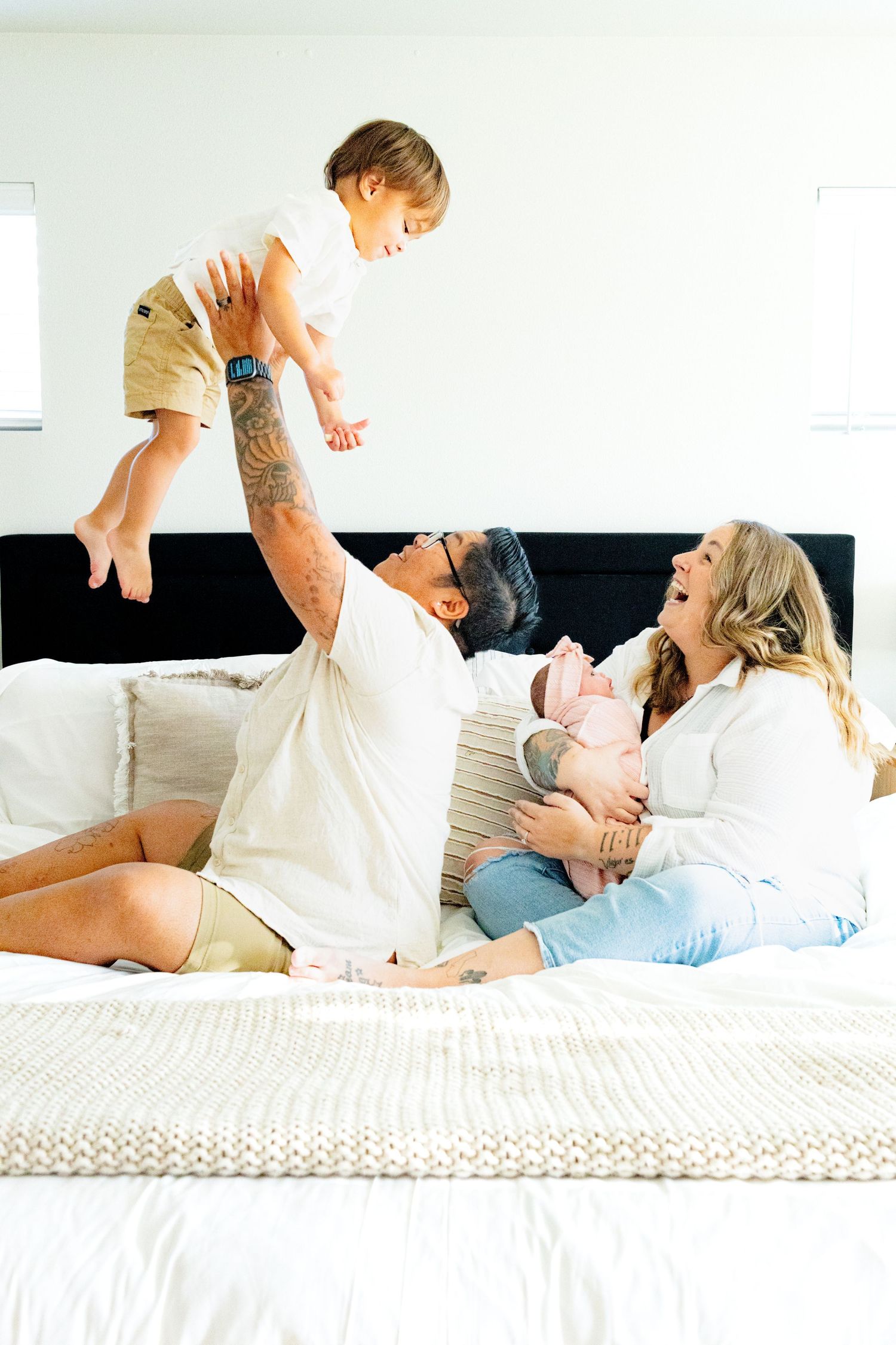 Indoor family newborn photo session with siblings. Lesbian family photo. Lesbian newborn family photo.