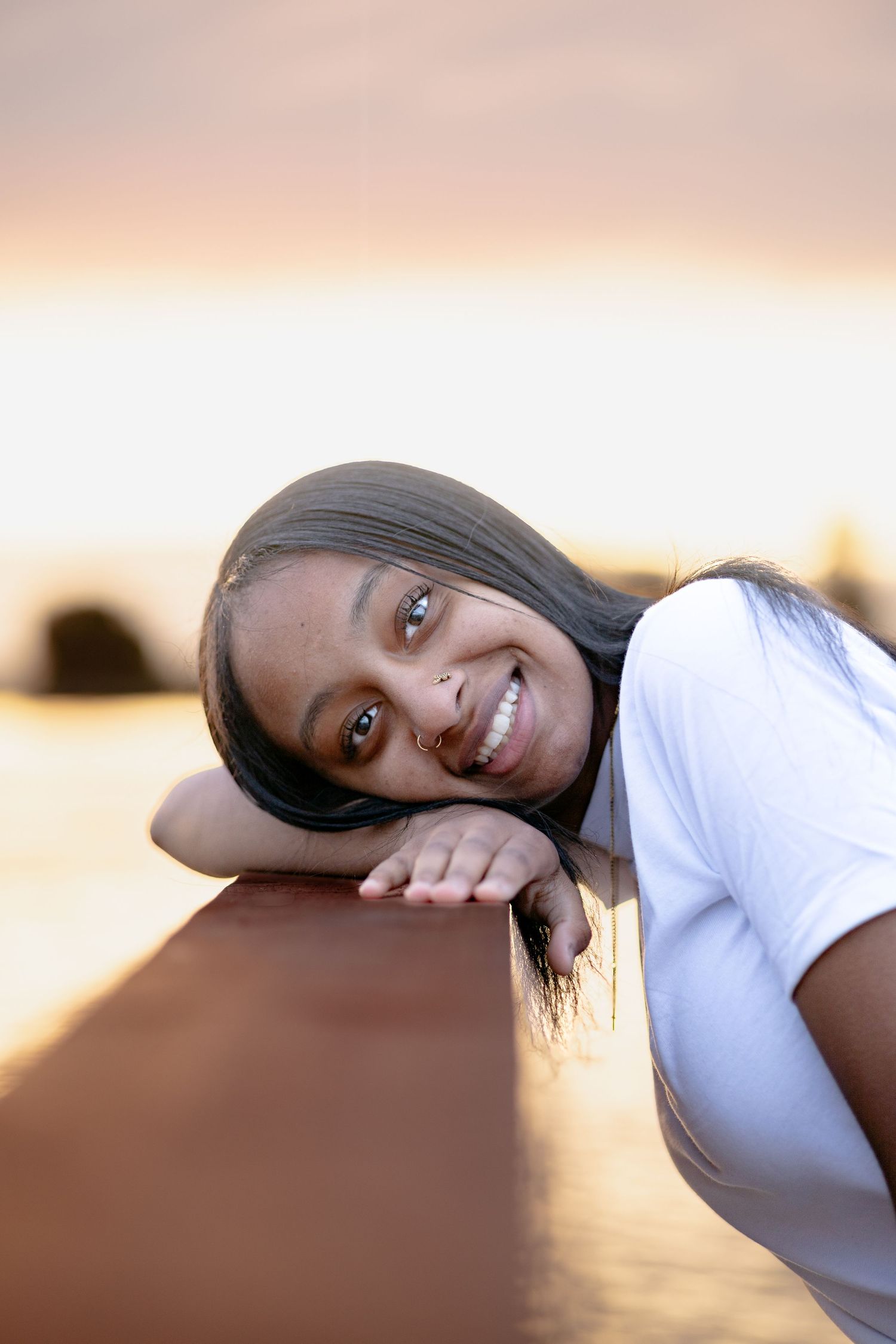 Senior photo at golden hour in Everett, Wa. Water in the background. Senior portrait
