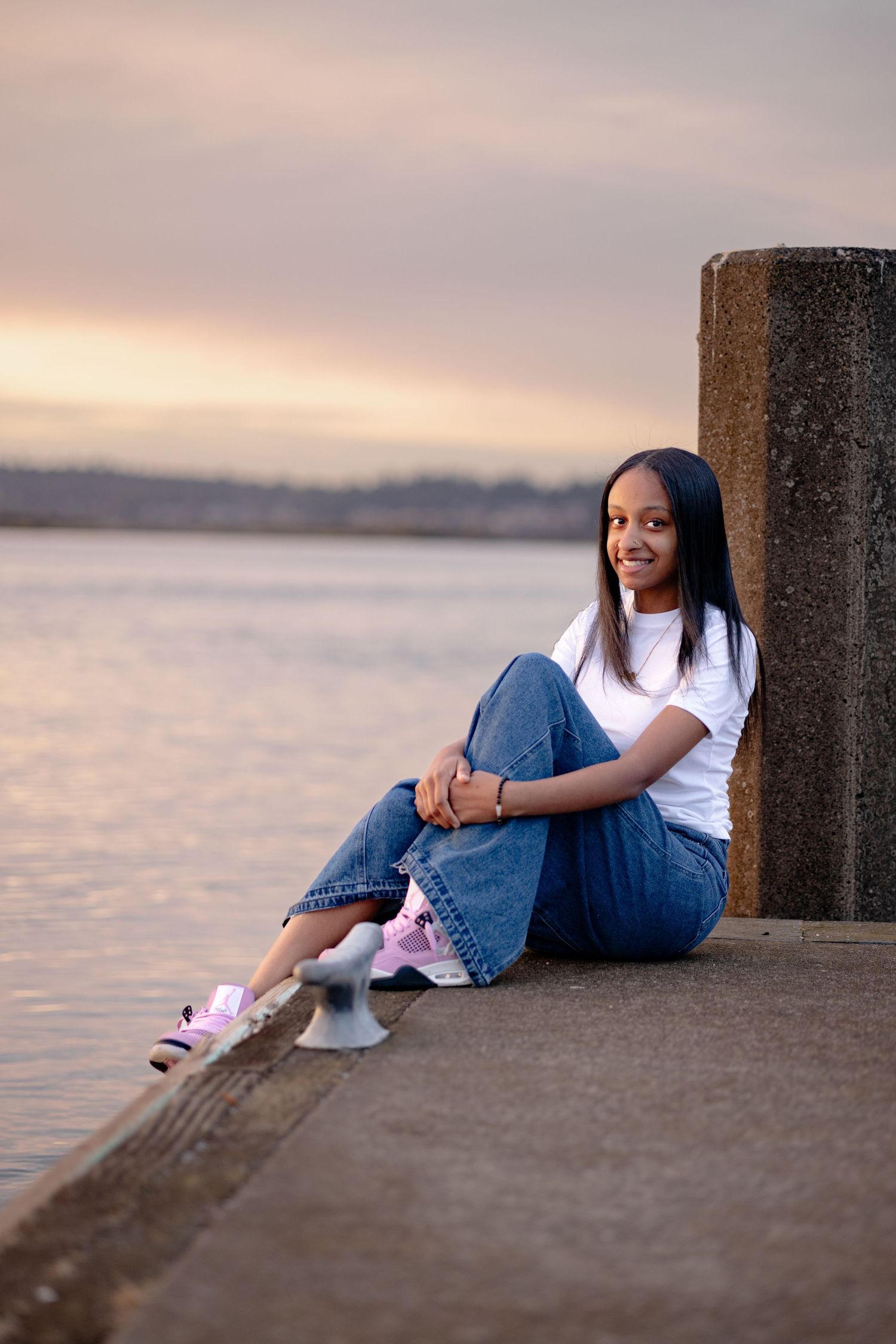 Senior photo at golden hour in Everett, Wa. Water in the background. Senior portrait.