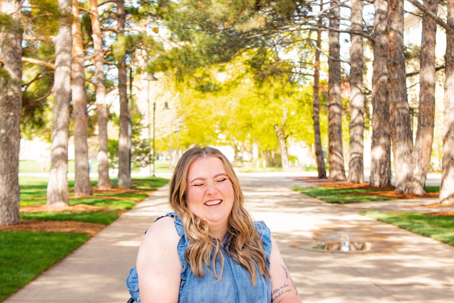Senior photo on USU campus in Logan, UT. outdoor senior photo. Foliage in the background. Rugged senior photo. Female senior photo