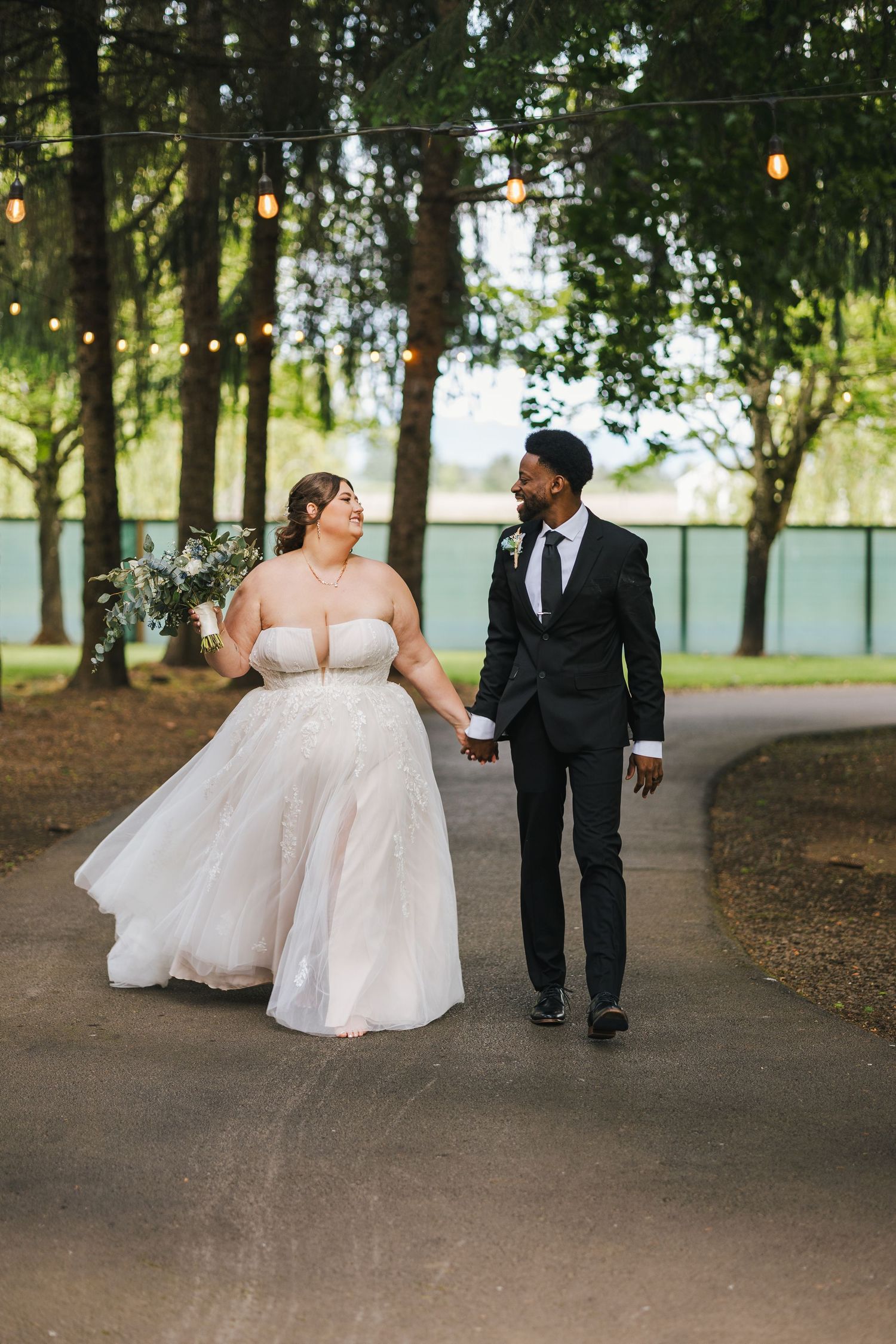 candid wedding photos in central Oregon at the water oasis. Beautiful wedding photos. Photo of the couple walking candid. Moody