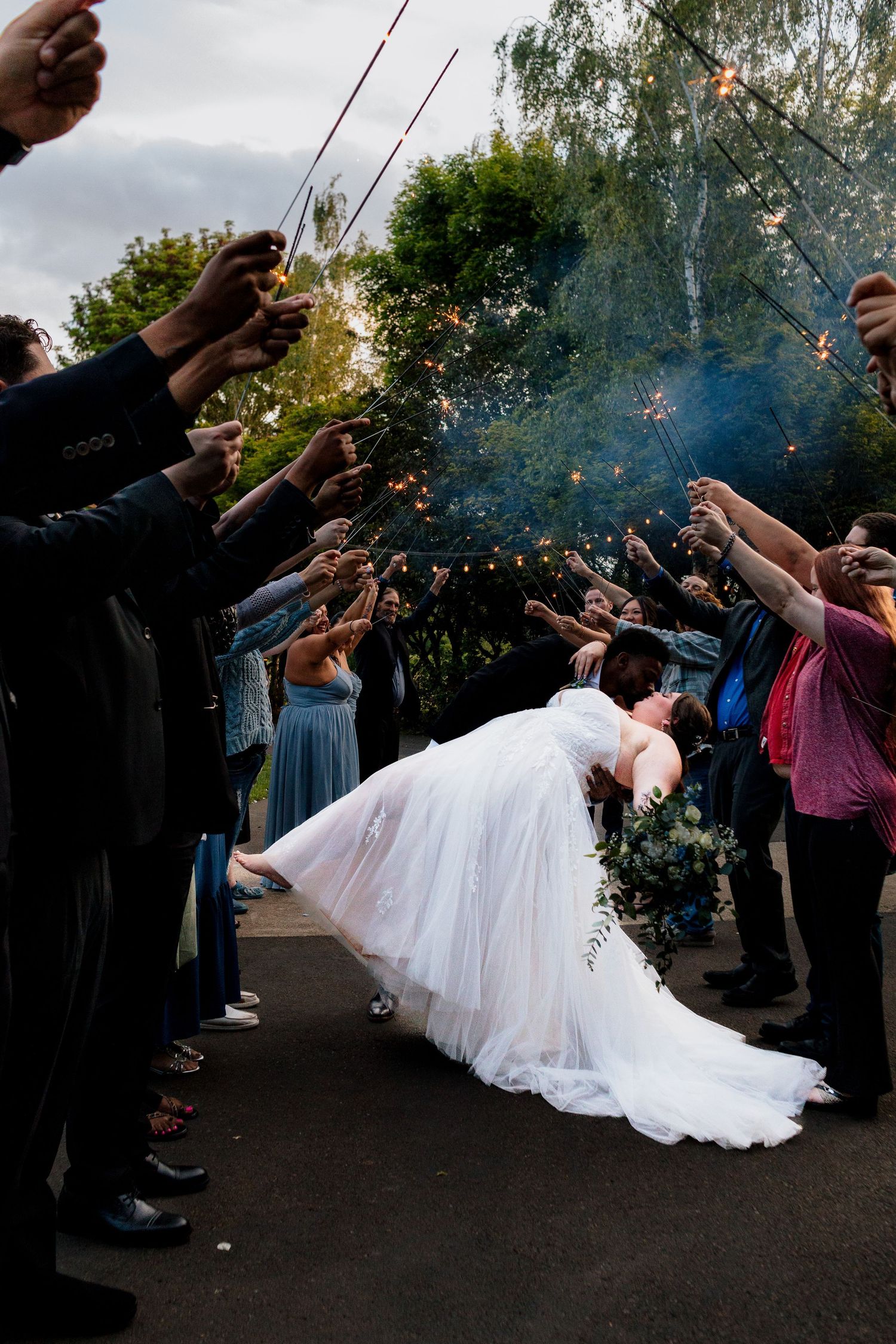 candid wedding photos in central Oregon at the water oasis. Beautiful wedding photos. Photo of the sparkler exit. Moody