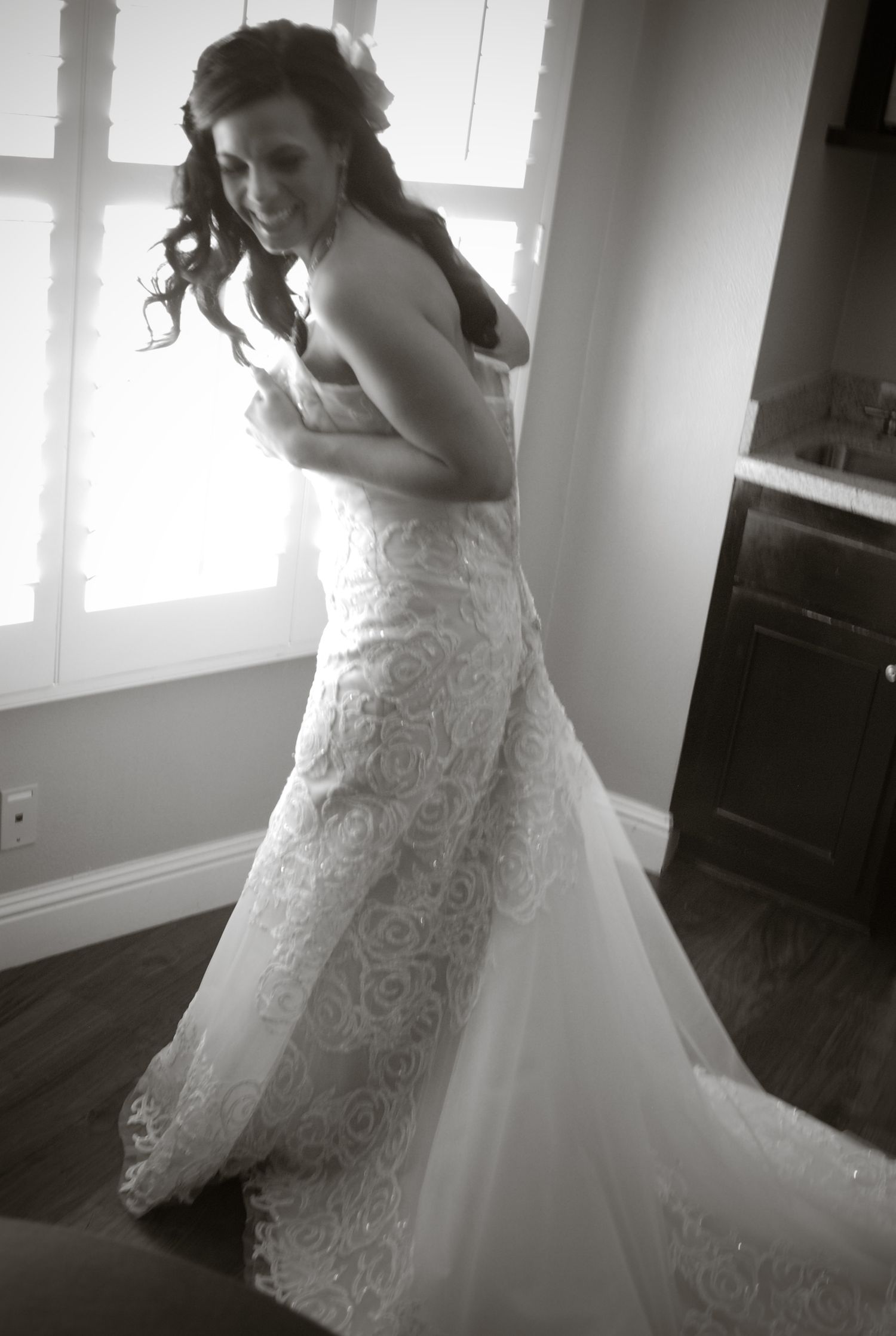Black and white photo sequence showing a wedding dress with delicate lace details and flowing tulle skirt.