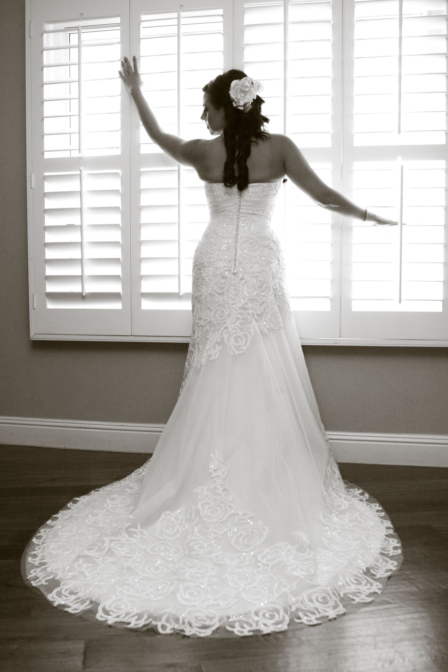 Classic white bridal gown with detailed lace train shown in multiple angles against white shutters.