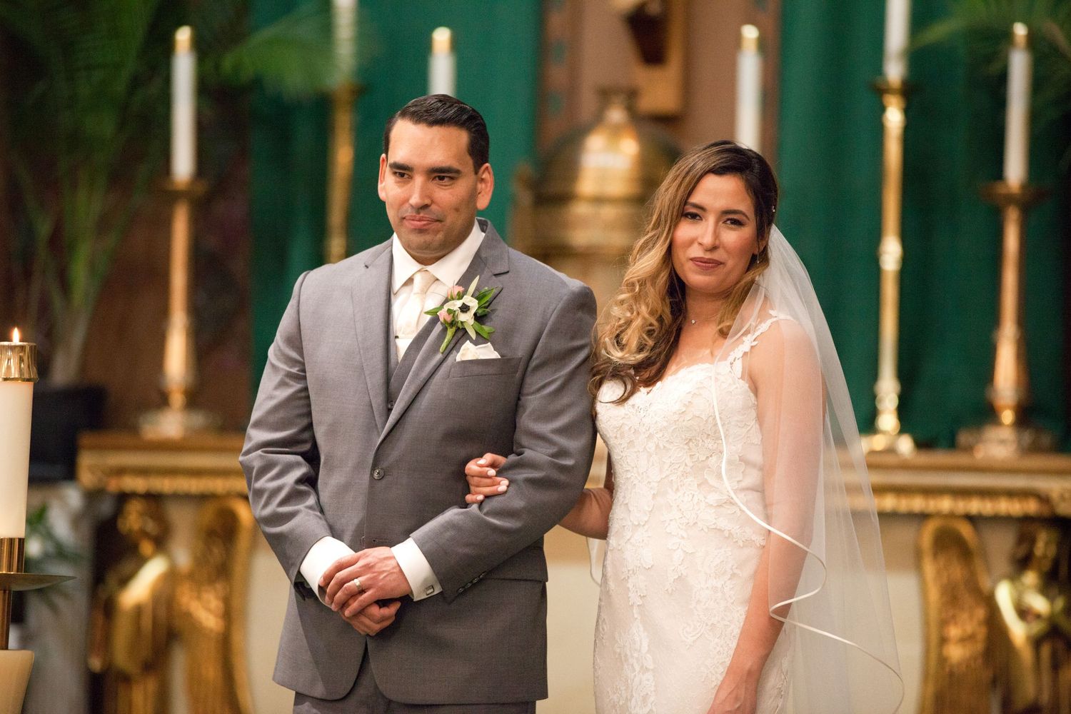 Wedding party proceeding down church aisle during traditional ceremony.