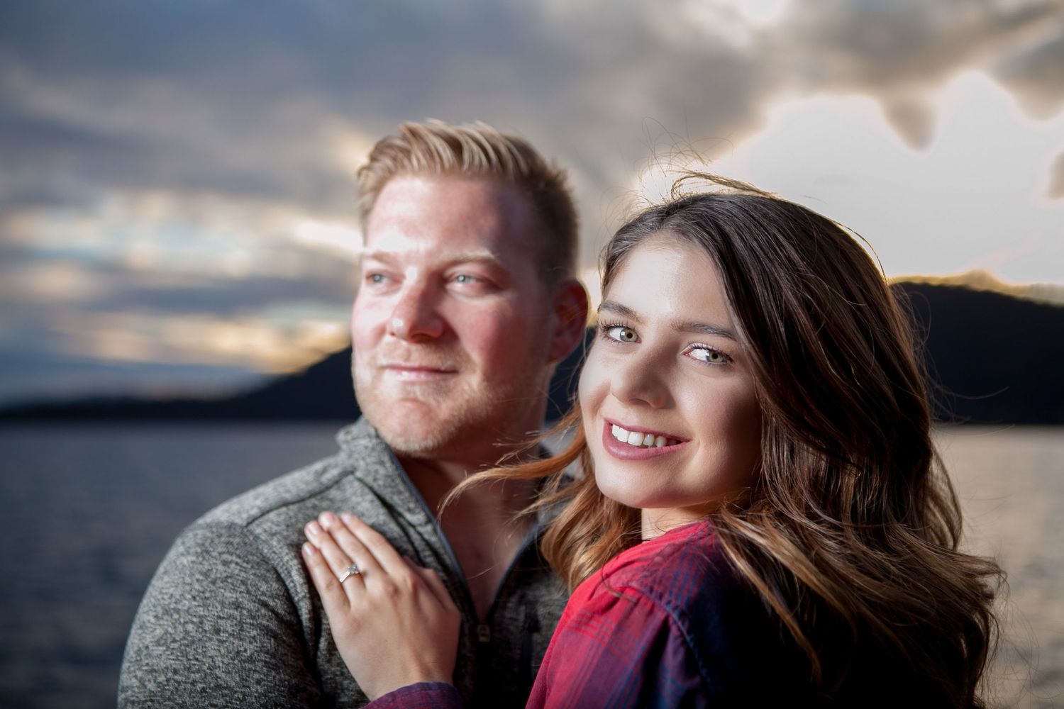 Engagement photos captured at lakeside with stunning sunset and mountain backdrop in Lake Tahoe.
