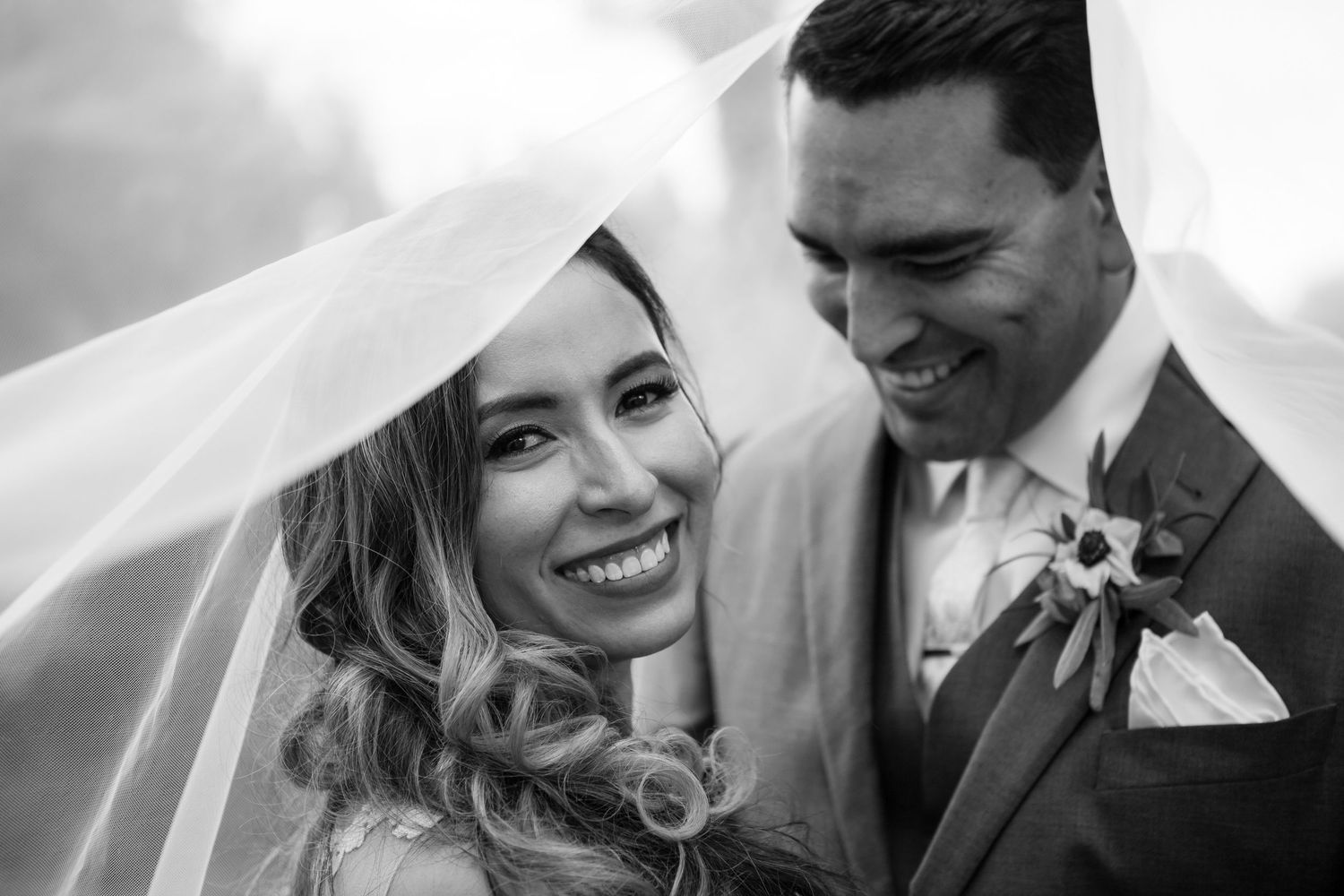Black and white portrait captures intimate wedding moment between couple.