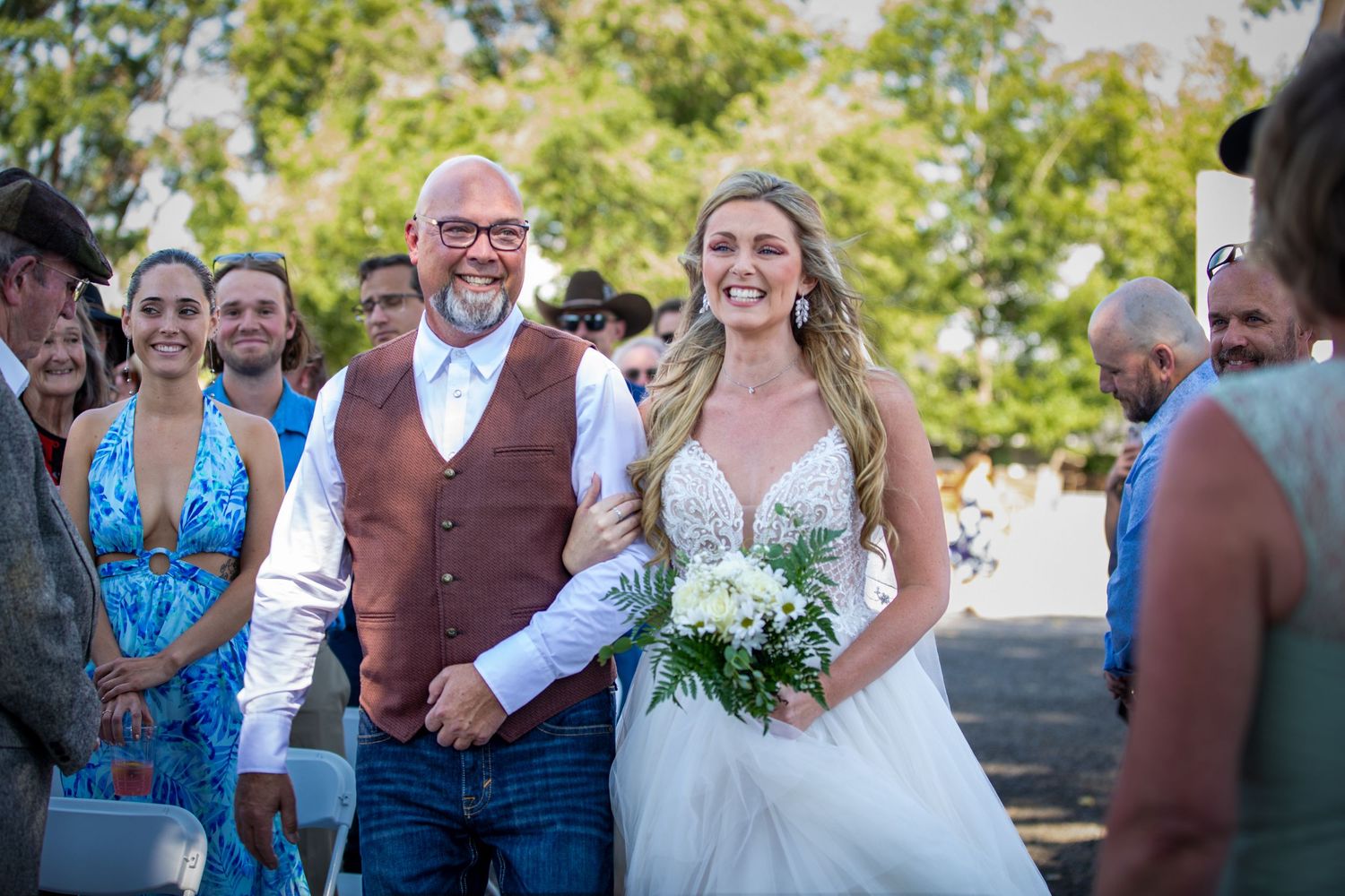 Wedding party celebrates outdoors during a summer celebration.