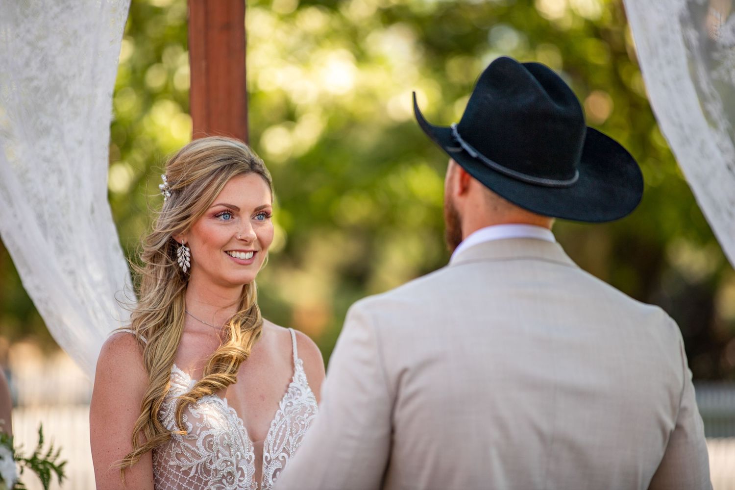 A couple shares a tender moment during their outdoor wedding ceremony.