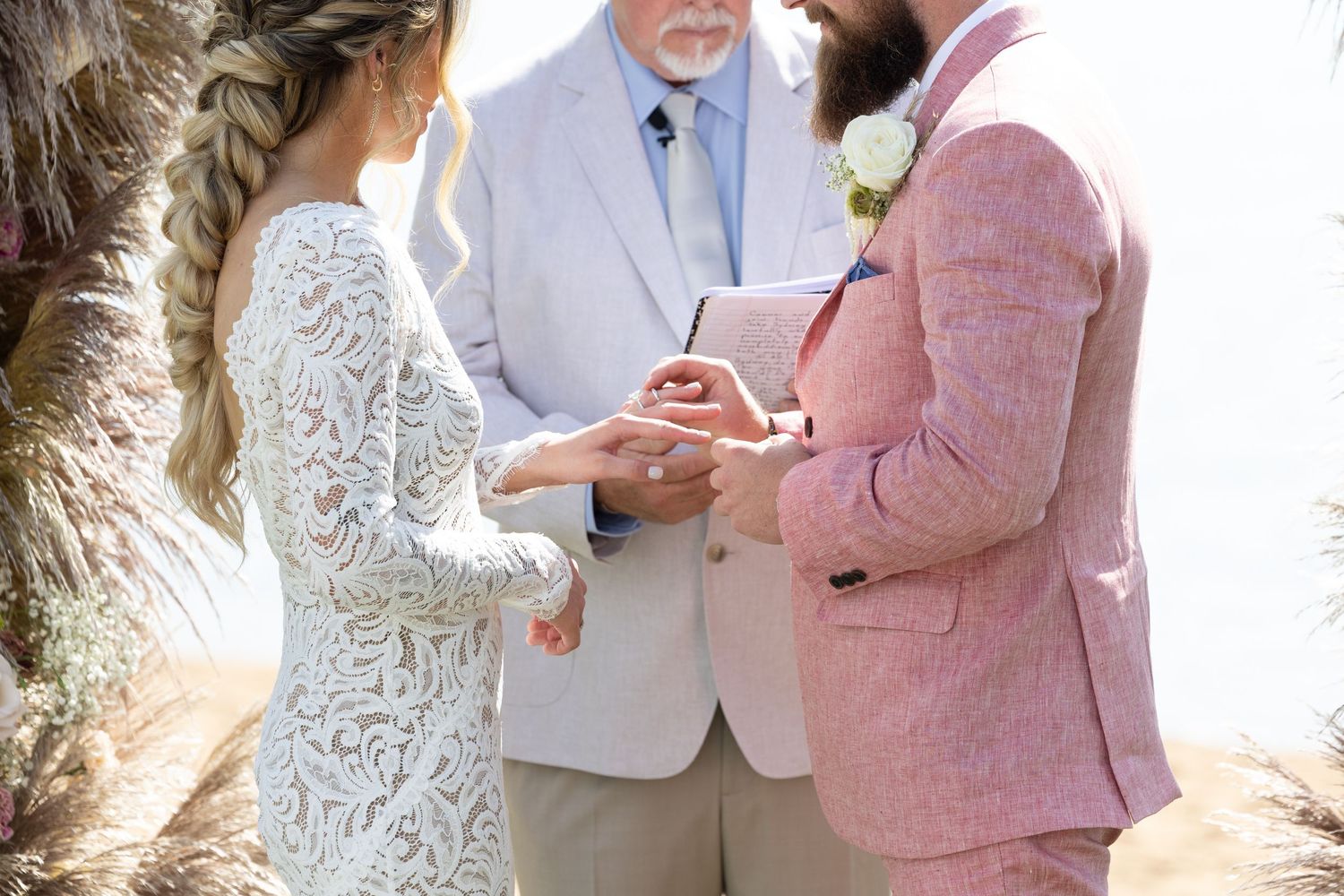 Wedding ceremony moment captured against natural outdoor backdrop with decorative elements.