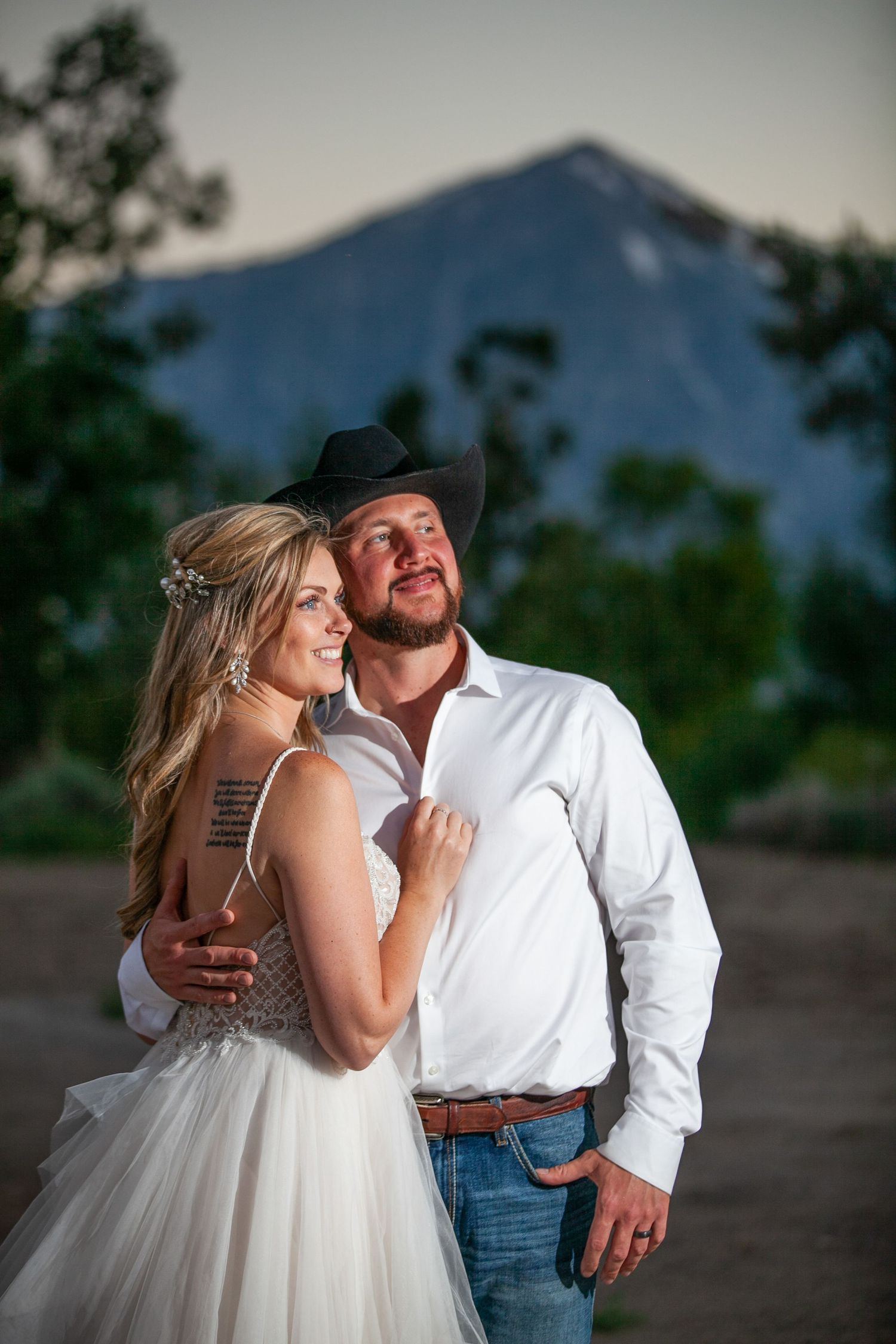 Sunset wedding portraits with mountain backdrop capture romantic moments.