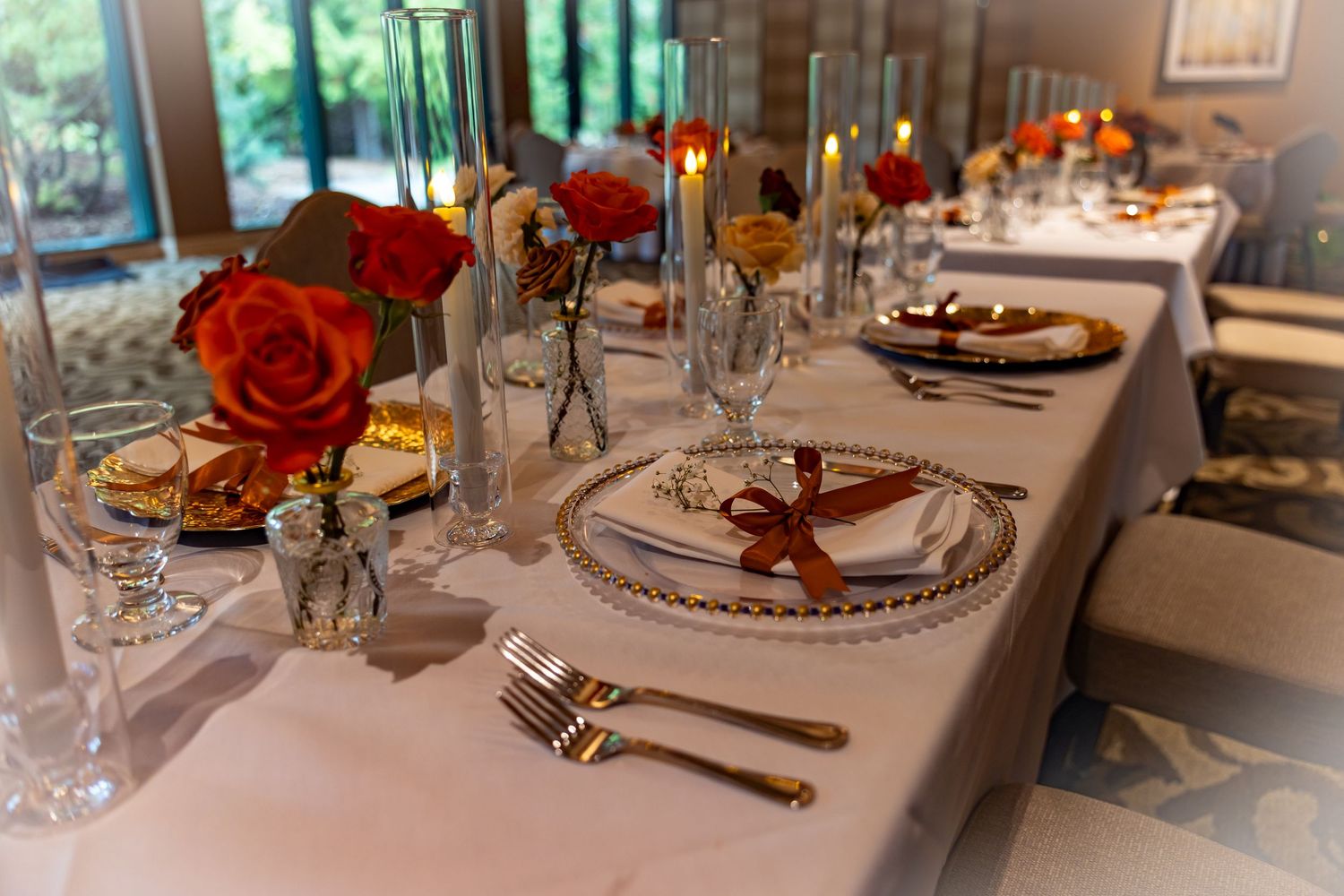 Brand and business photography of an elegant table settings with red rose centerpieces at a formal dining and family event.