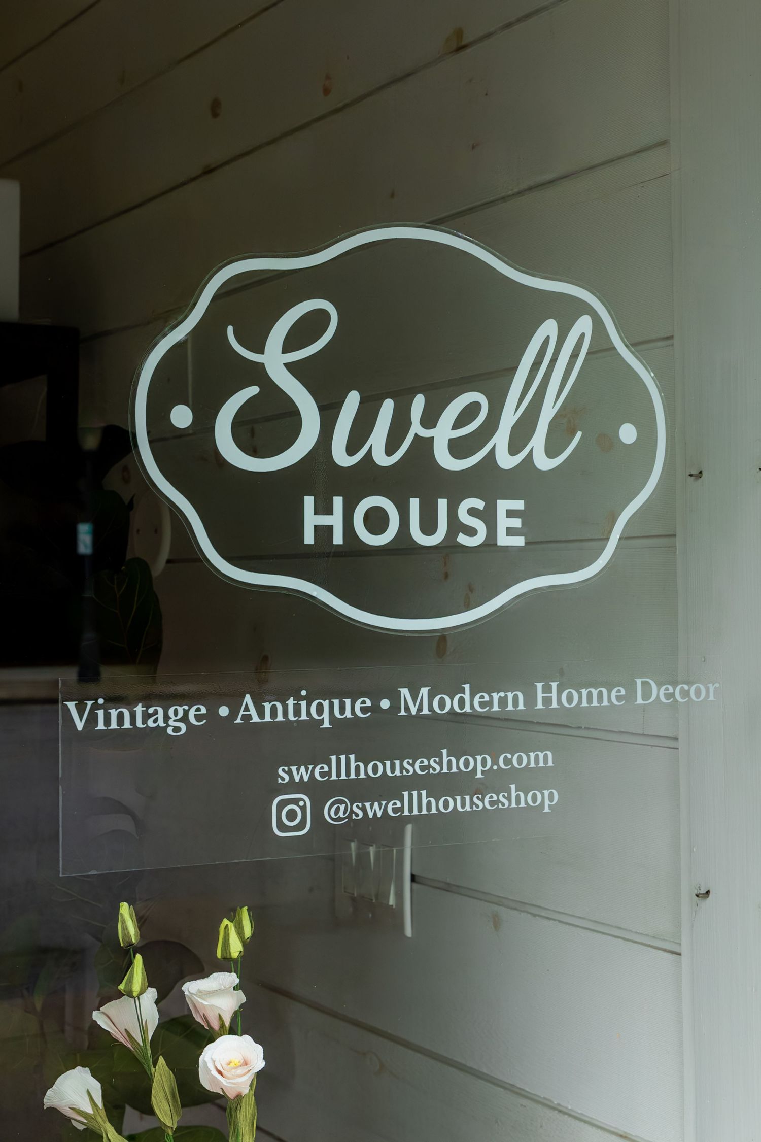 Swell House La Grange shop sign on glass door advertising vintage, antique, and modern home decor with website and Instagram handle.