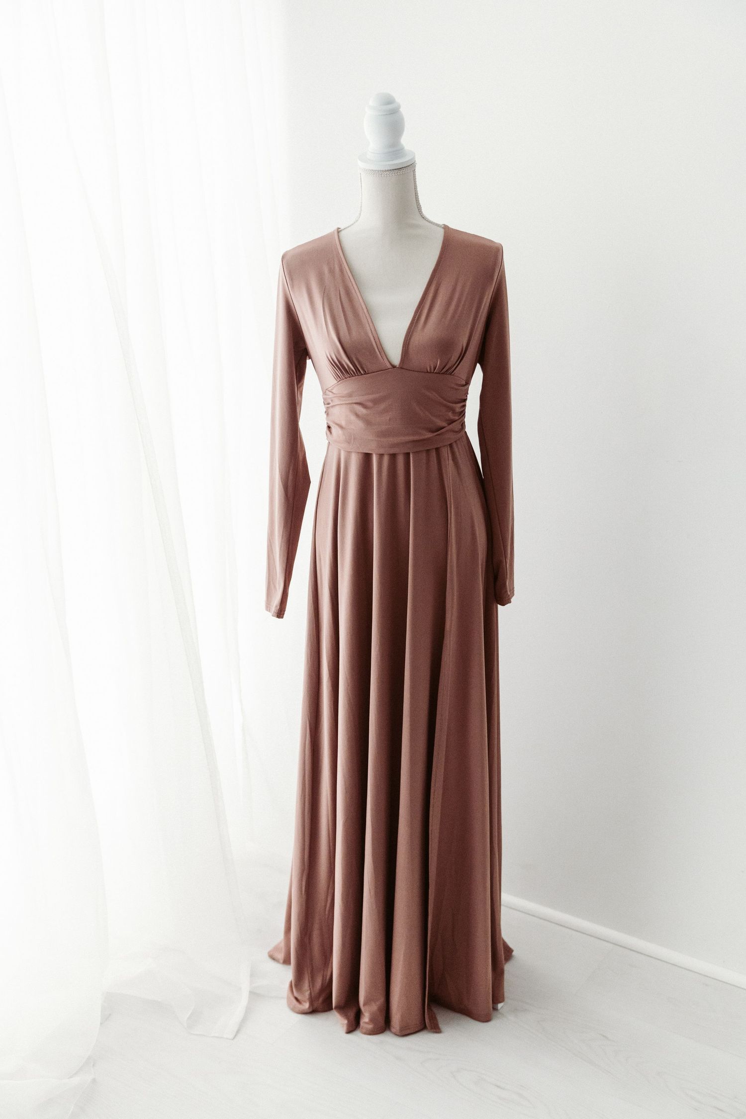 Mauve deep V-neck long sleeve wrap style flowy maxi dress on mannequin.
