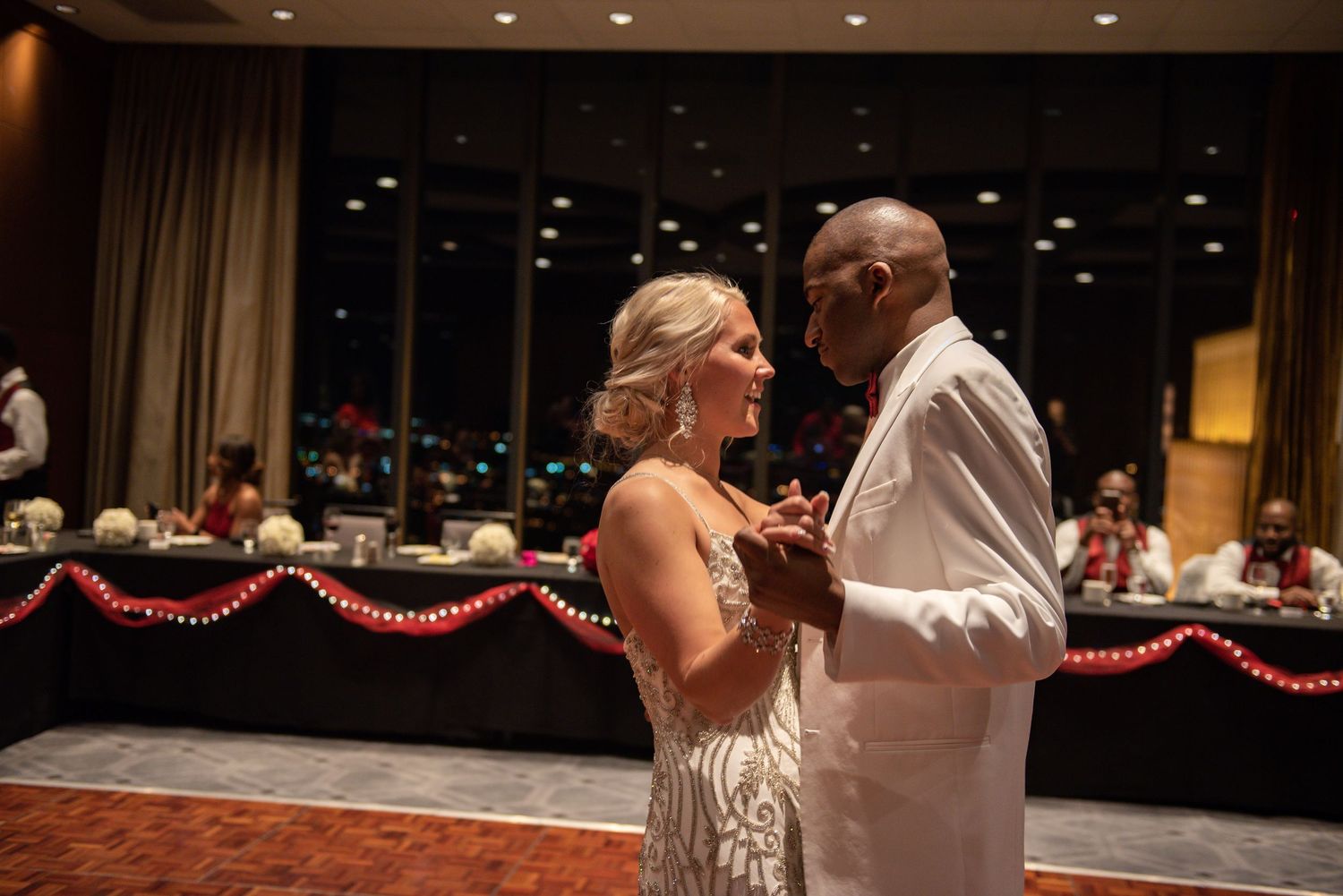 Bride and groom sharing a romantic first dance at their elegant wedding reception.