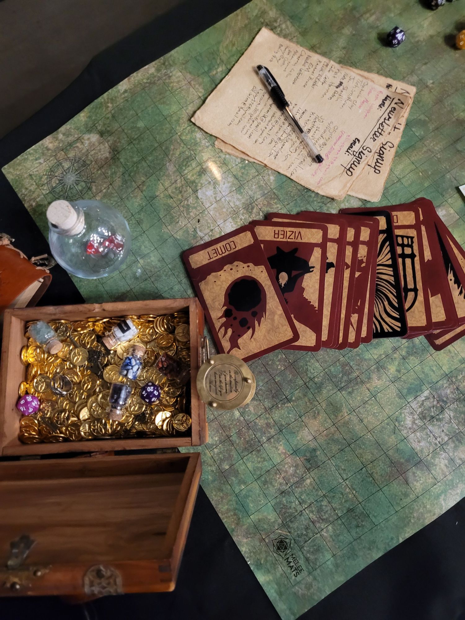 dnd trinkets: parchment, pen, tarot card deck, crafted glass potion bottle, small chest with gold coins and dice inside