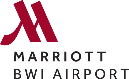Red and white Marriott hotel logo signage displayed on a modern building exterior.