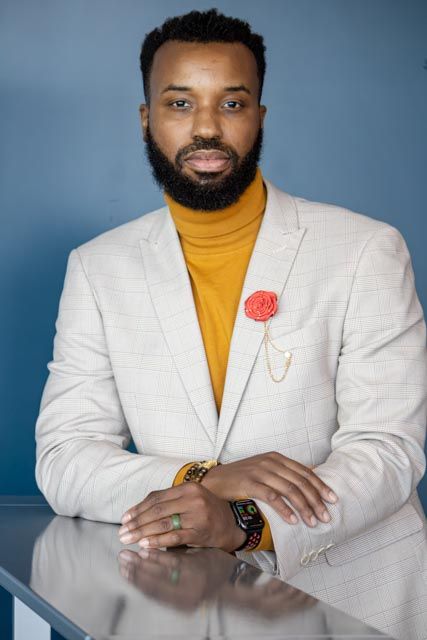 Professional studio portraits showing a person in a white blazer and yellow turtleneck against a blue backdrop.