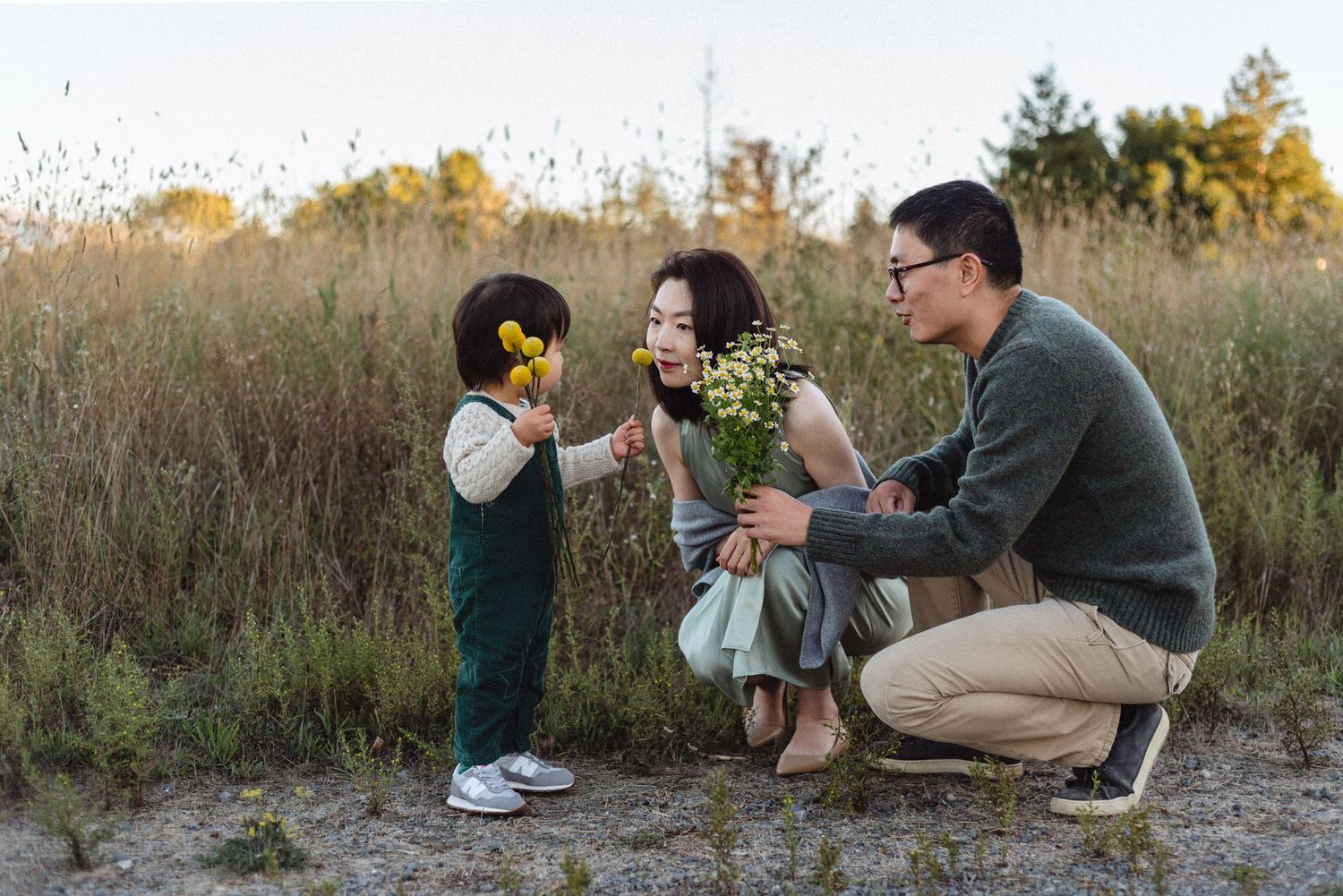 A touching family scene with wildflowers in a golden autumn field.