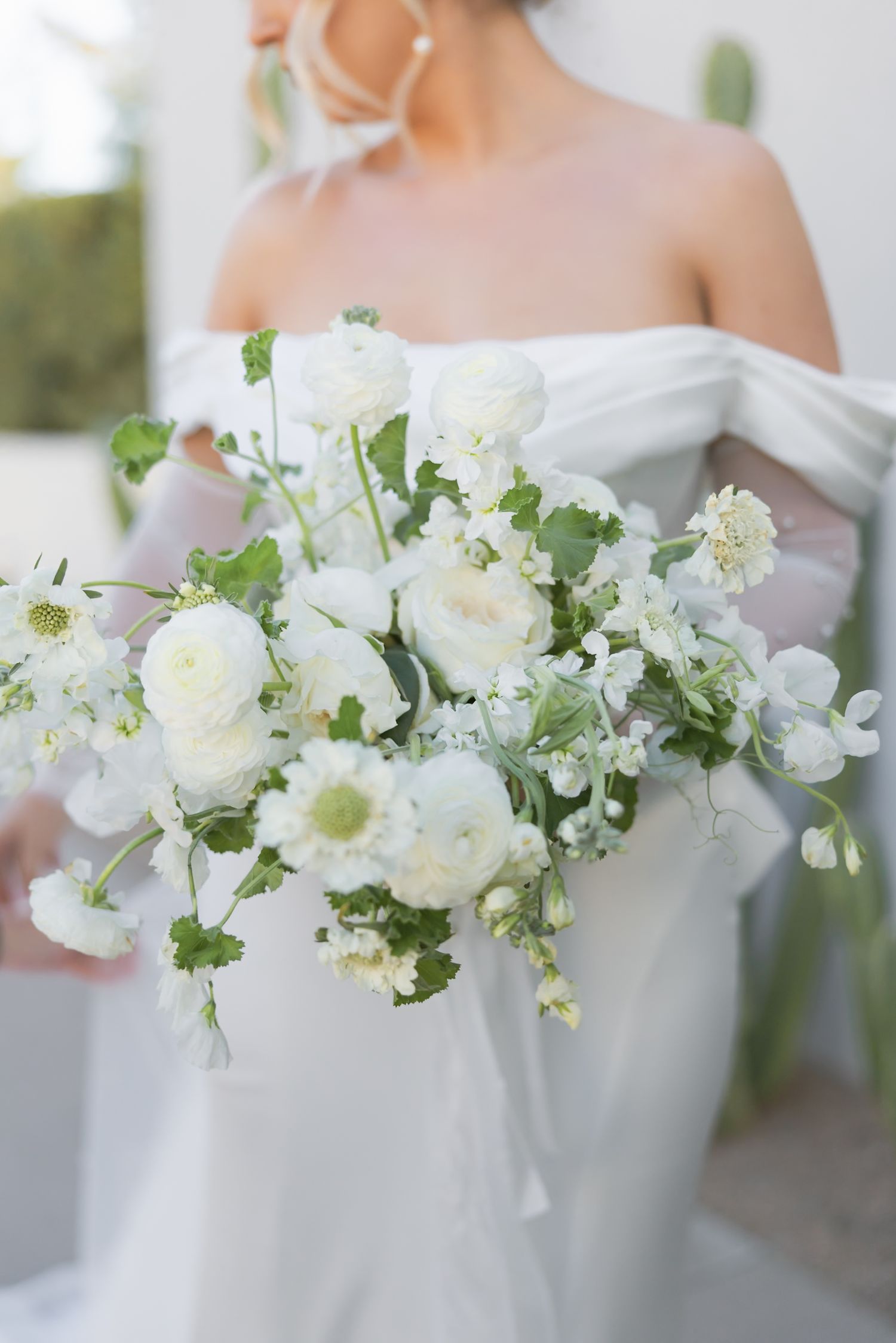Elegant white and green floral wedding bouquet with delicate blooms.