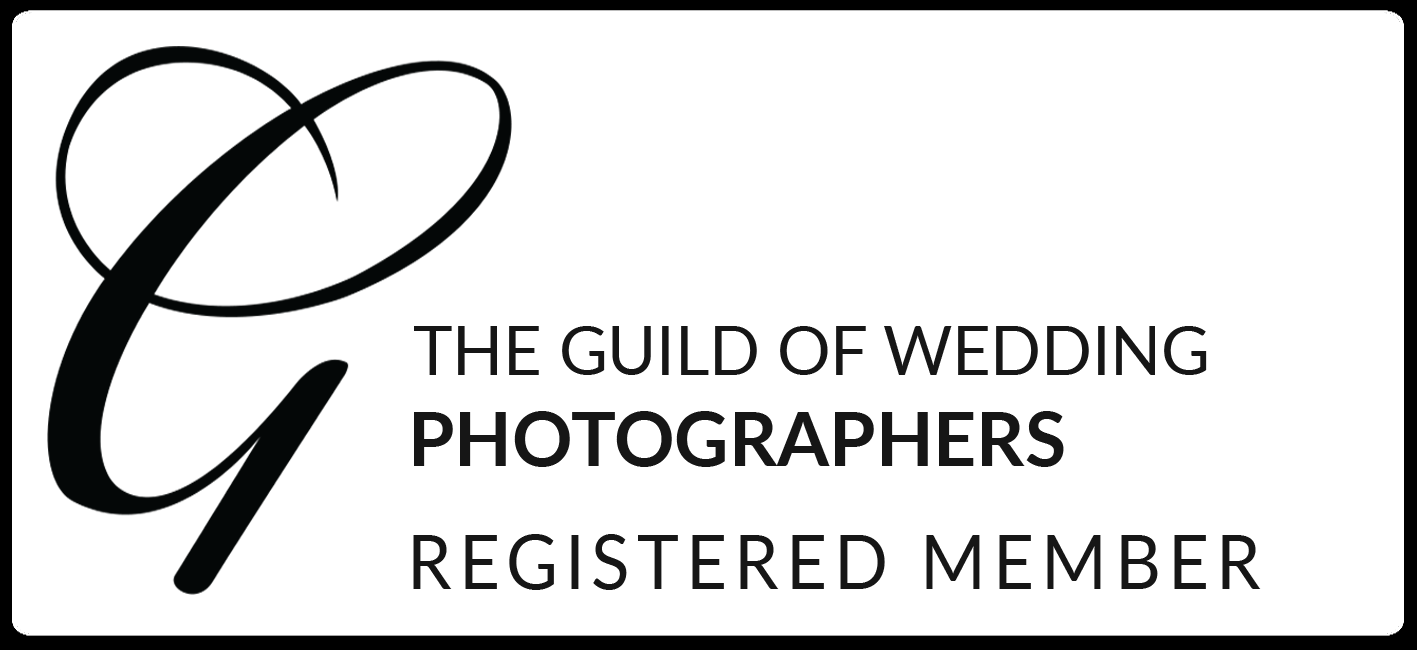 Black and white logo for The Guild of Wedding Photographers Registered Member.