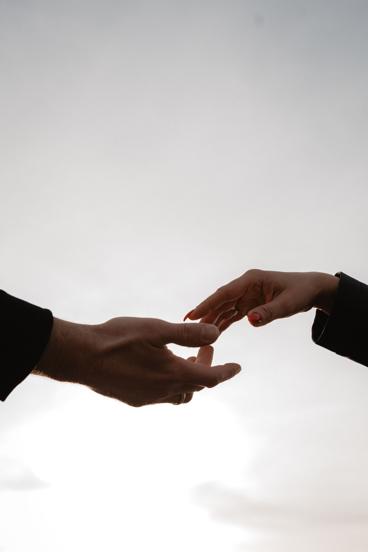 A series of hands reaching towards each other against a white background, showing a progression of connection.