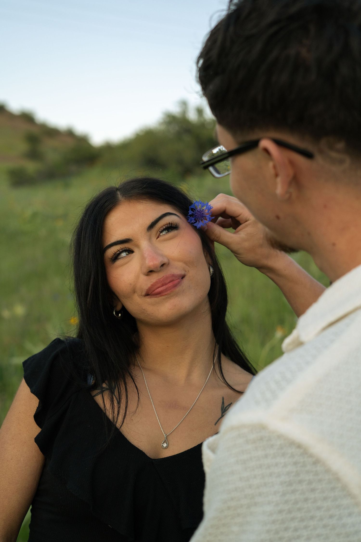 Couple photo with flower behind ear.