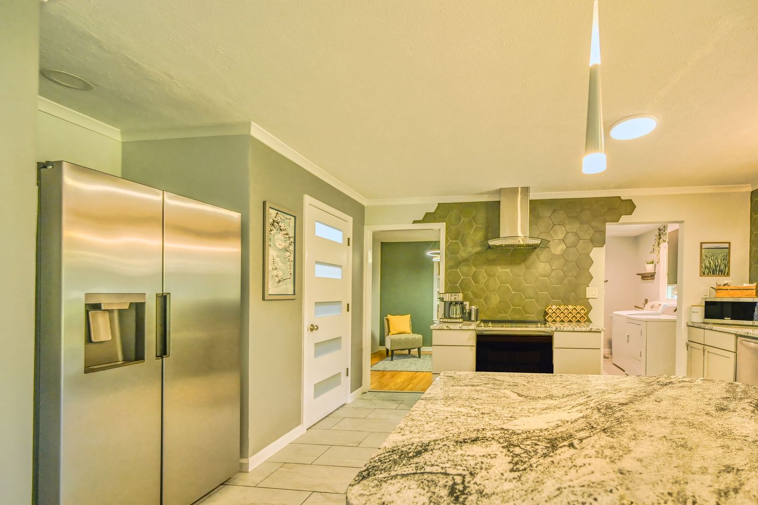 Real estate interior photograph of an open kitchen and living area
