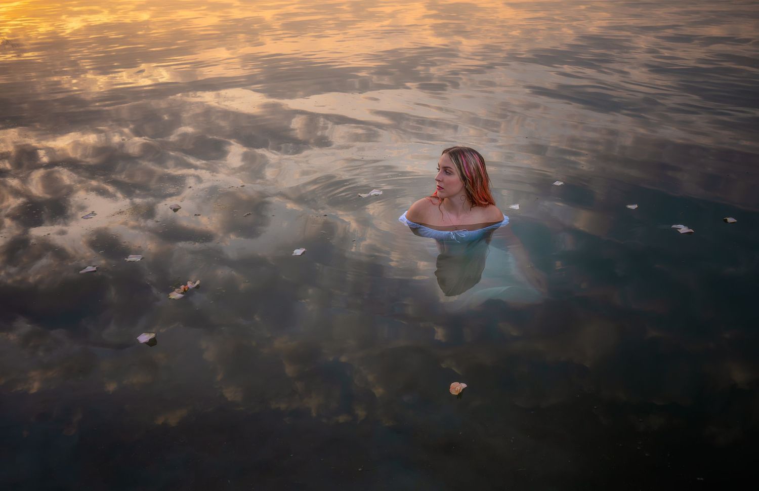 Creative aerial portrait photographed in reflective water at sunset