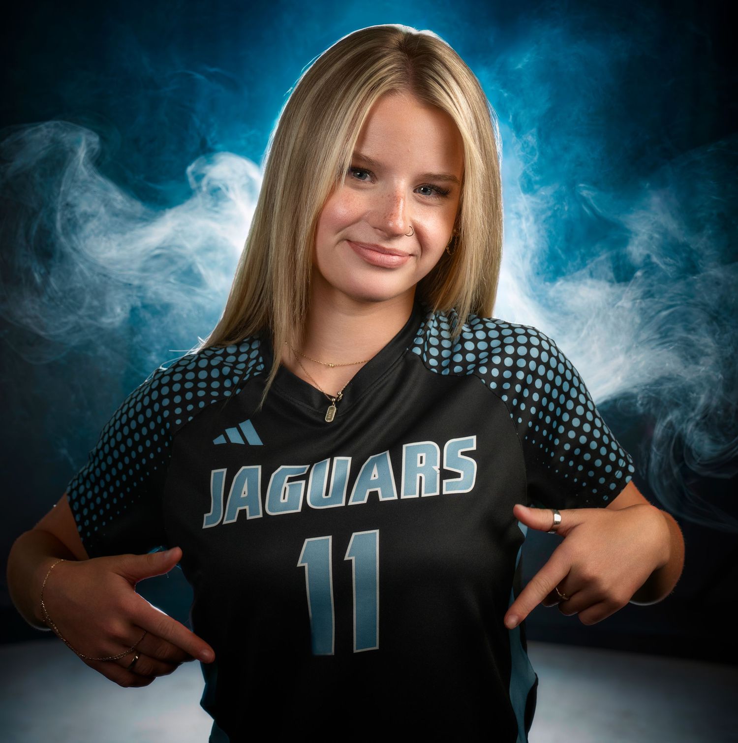 High school athlete media day portrait in a Jaguars uniform with blue fog