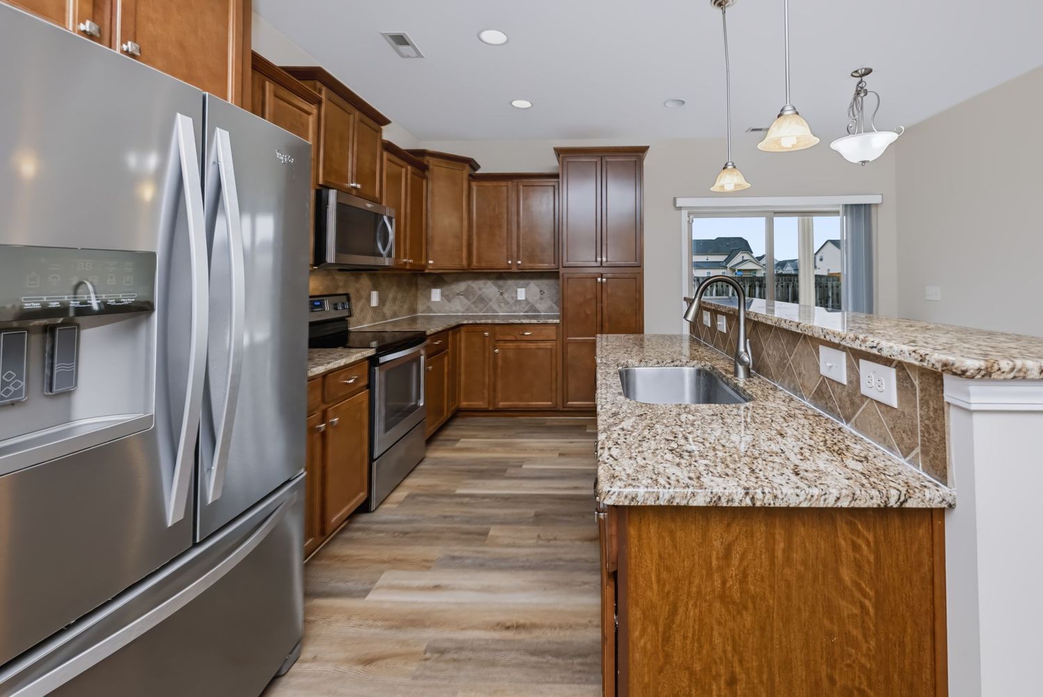 Professional real estate photograph of a kitchen with center island