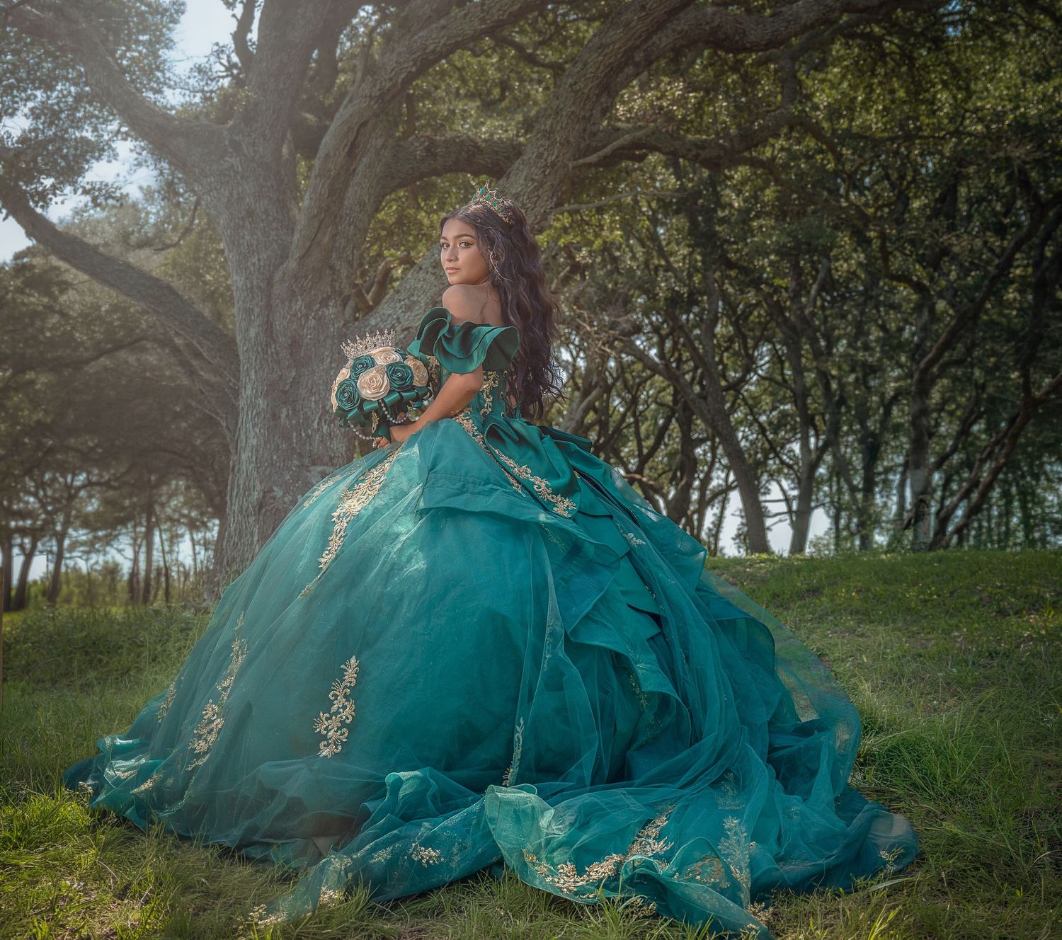 Editorial portrait featuring an emerald green formal gown