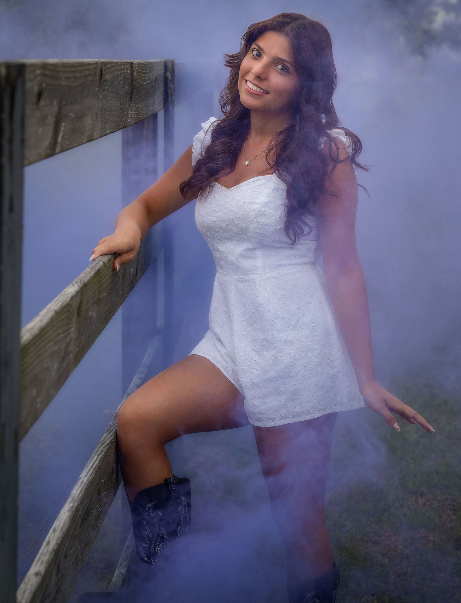 Creative portrait in a white dress with atmospheric fog